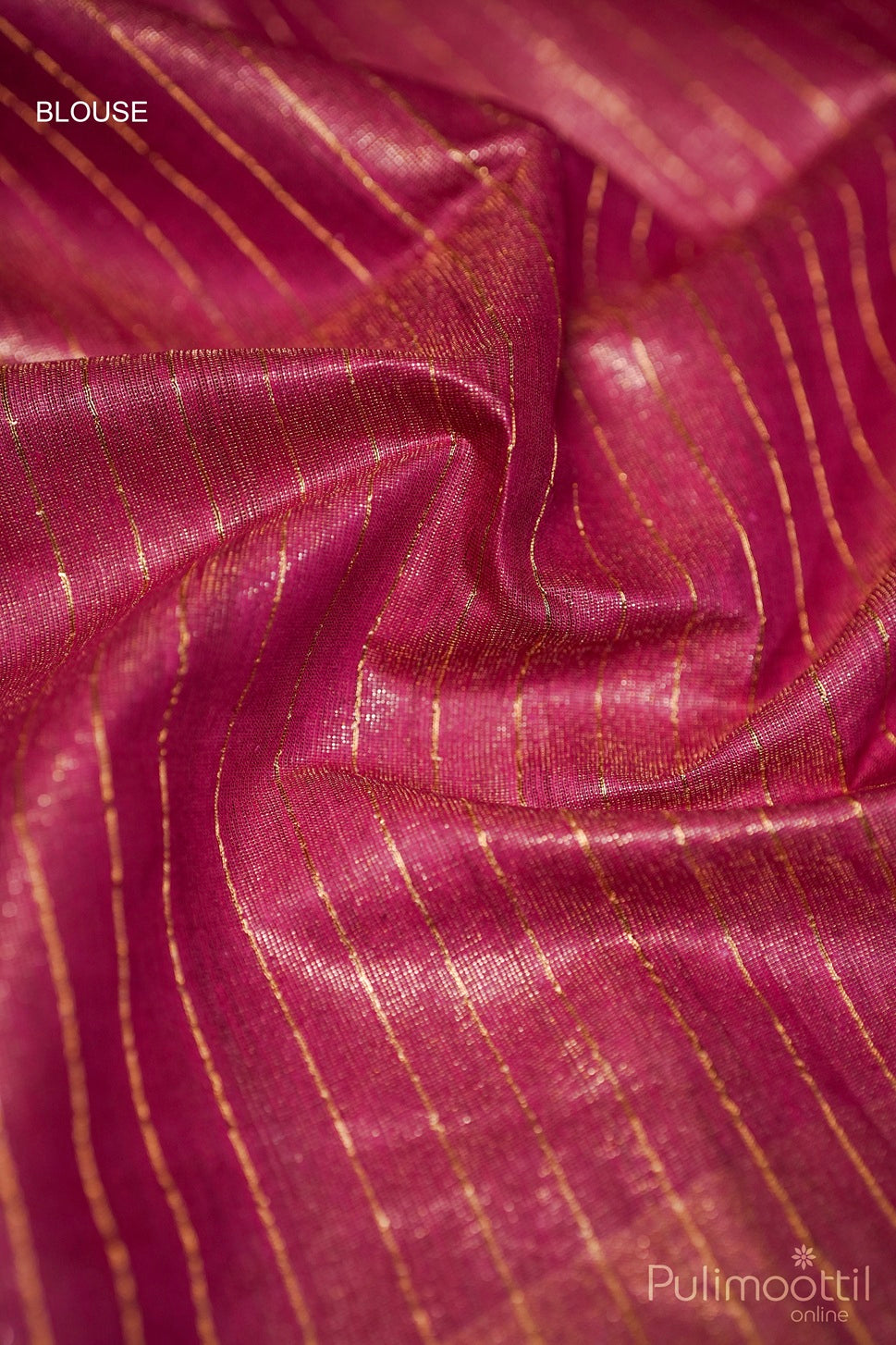 Close-up of purple kanjipura fabric with gold stripes, branded 'Pulimoottil'.