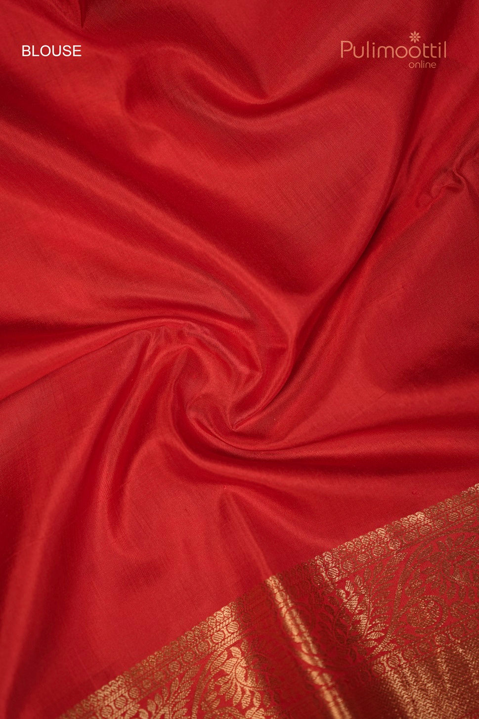 Red blouse fabric with a golden zari border featuring intricate floral motifs at the edge