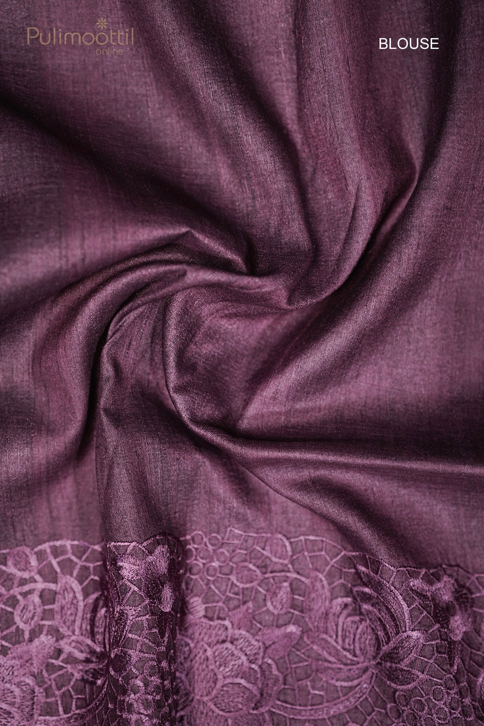 urple saree blouse piece with a floral lace border, fabric gathered in a swirl.