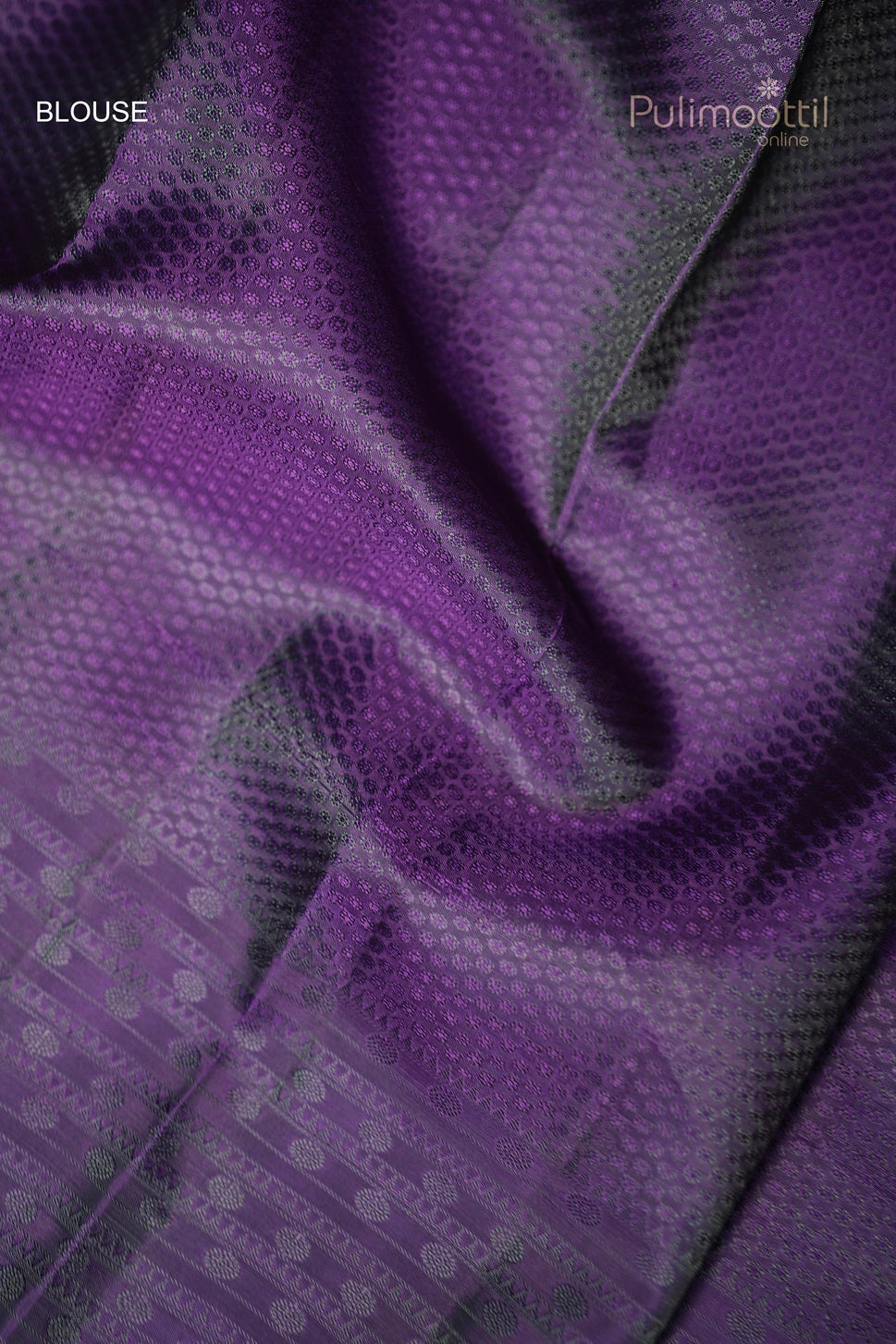 Close-up of the self print blouse piece of the violet Kanchipuram saree, showing detailed texture.