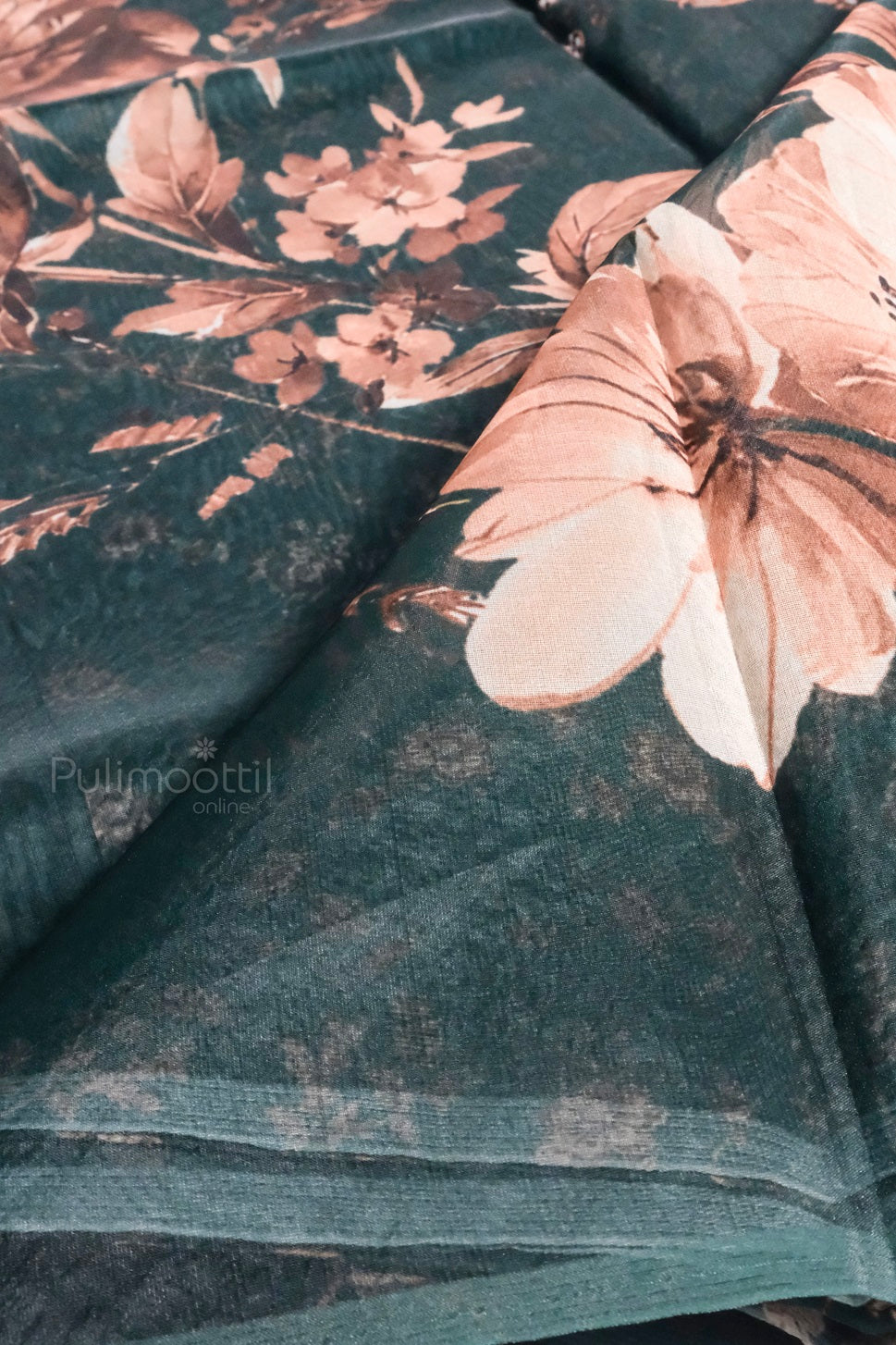Close-up view of soft organza fabric with peach and copper floral design.