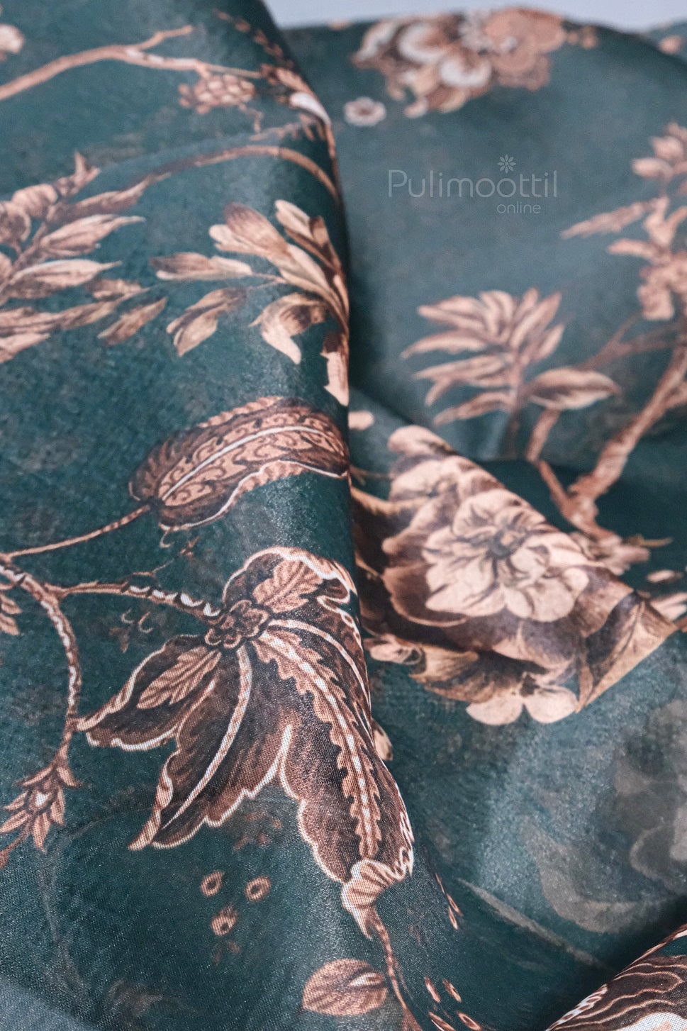 Close-up view of soft organza fabric with peach and copper floral design.
