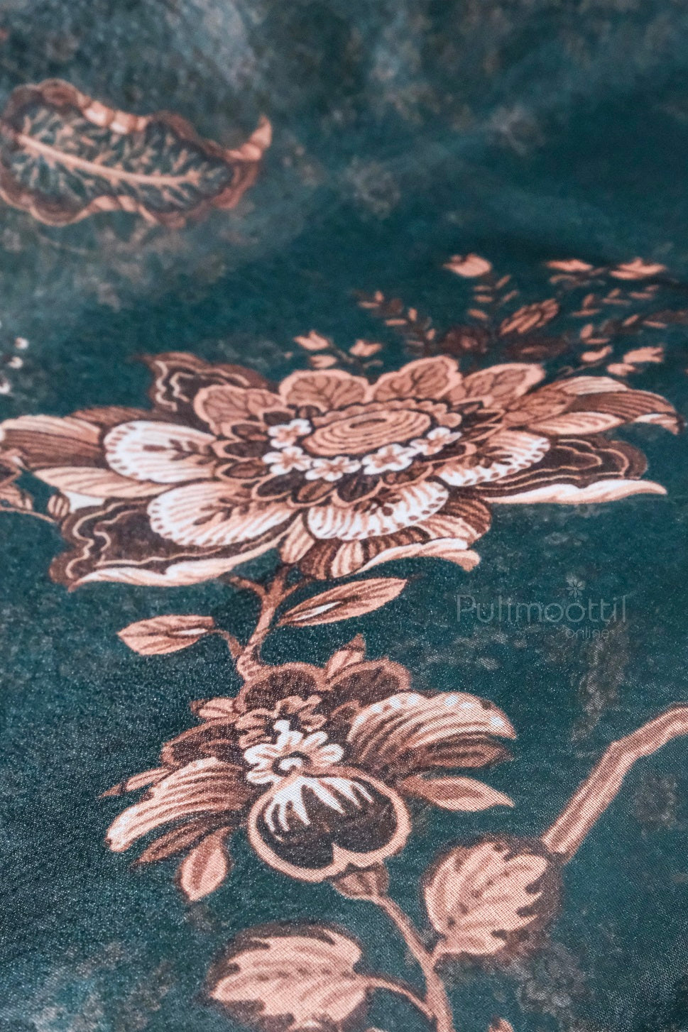 Close-up view of soft organza fabric with peach and copper floral design.