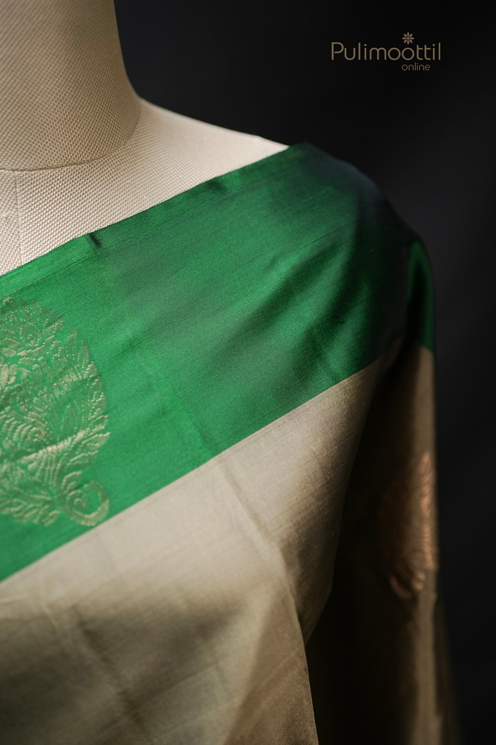 Close-up of pastel olive green Kanchipuram soft silk saree showing golden buttas and rich contrast green border with intricate zari work, perfect for wedding and bridal sarees by Pulimoottil Silks Thrissur.