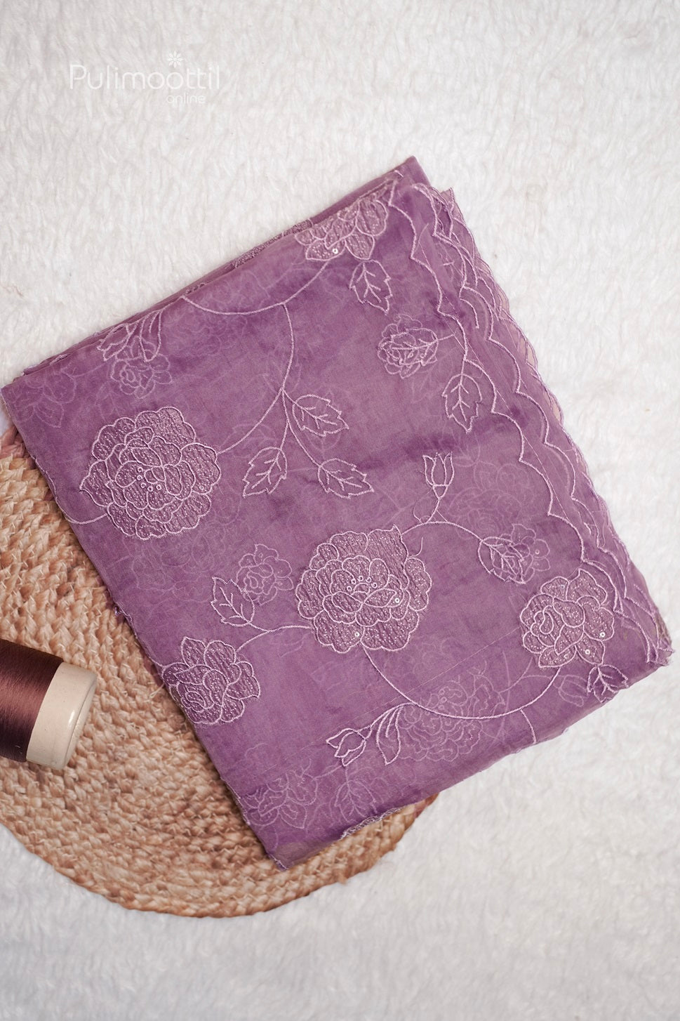 Folded lavender organza saree with cut work and embroidery on body and scallop border, perfect for wedding and bridal sarees from Thrissur Pulimoottil Silks.
