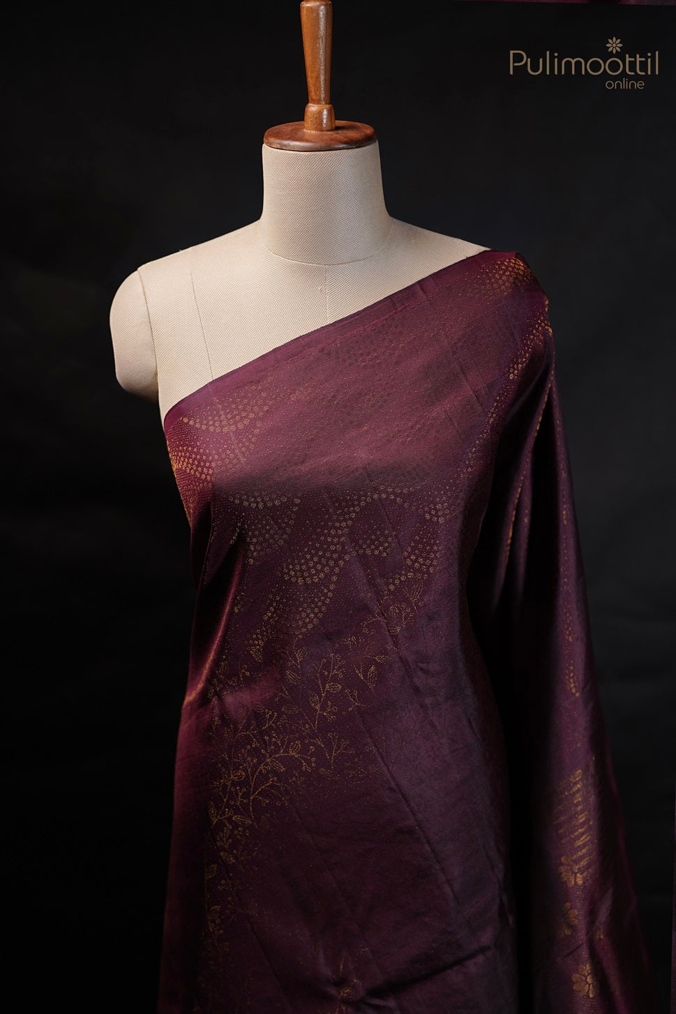 Close-up view of the saree draped on a mannequin, focusing on the intricate designer body pattern without a border.