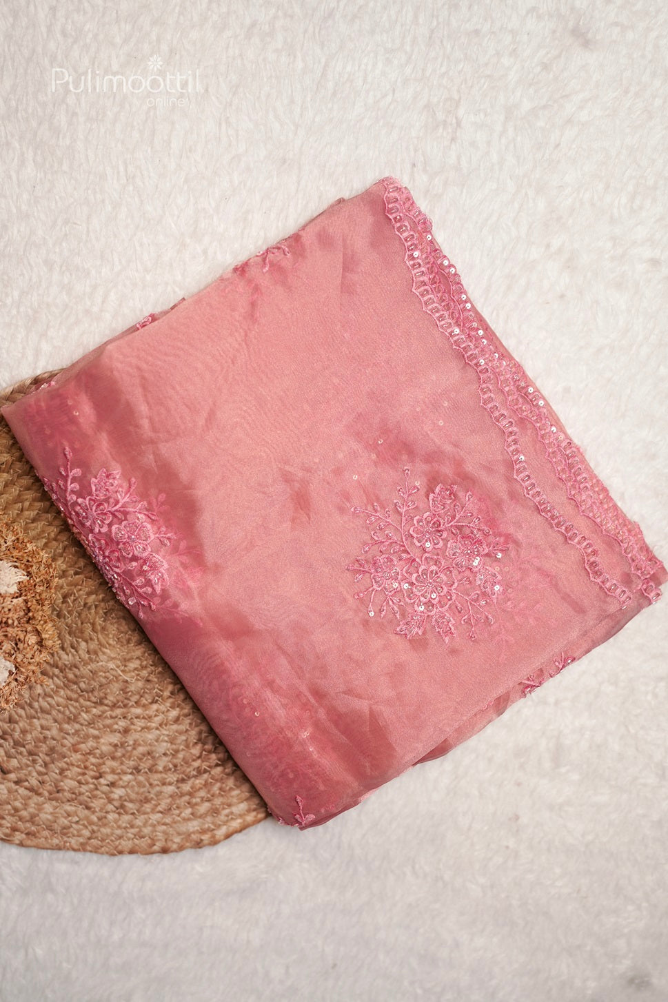 Folded light deep pink organza saree featuring intricate thread and sequins embroidery with scallop border, elegant choice for bridal and wedding sarees by Pulimoottil Silks Thrissur.