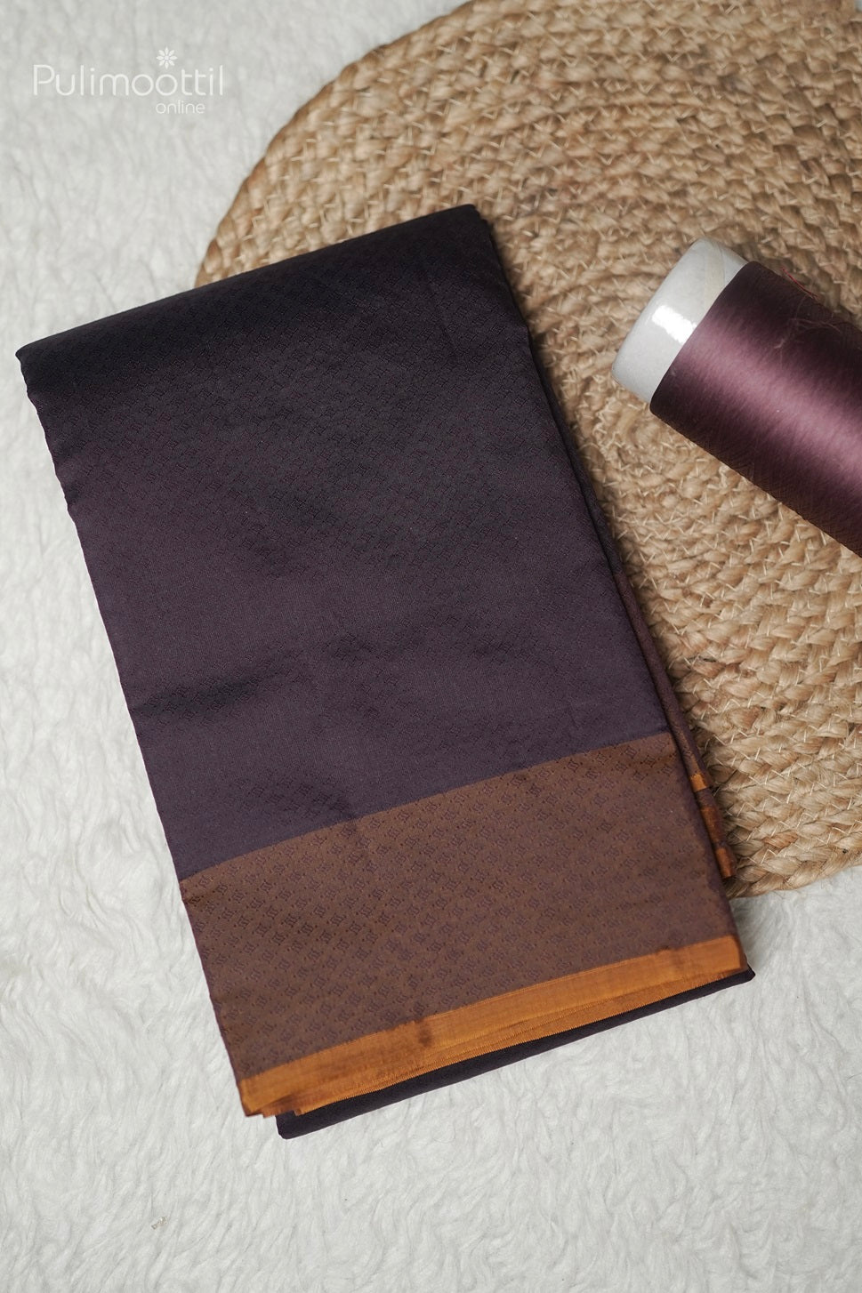 Folded purple Kanchipuram saree showing contrast golden yellow pallu and border