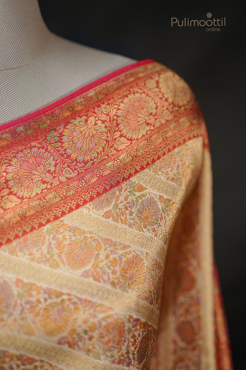 Pastel multishaded organza fancy saree draped on mannequin with broad multicolored stripes, golden buttas, and vertical striped border, perfect for wedding and bridal sarees from Pulimoottil Silks.