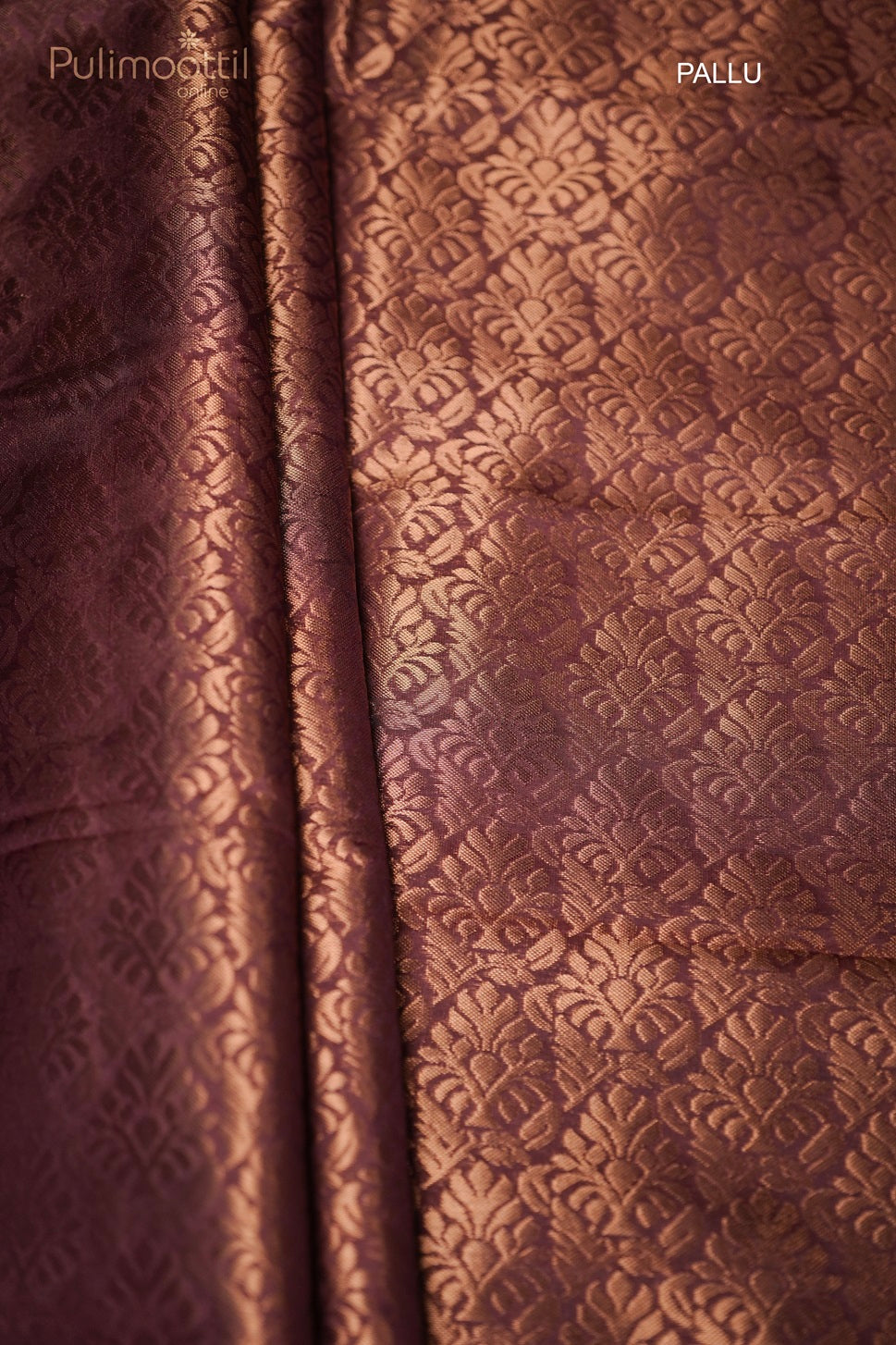 Copper designer pallu with intricate pattern on terracotta Kanchipuram saree