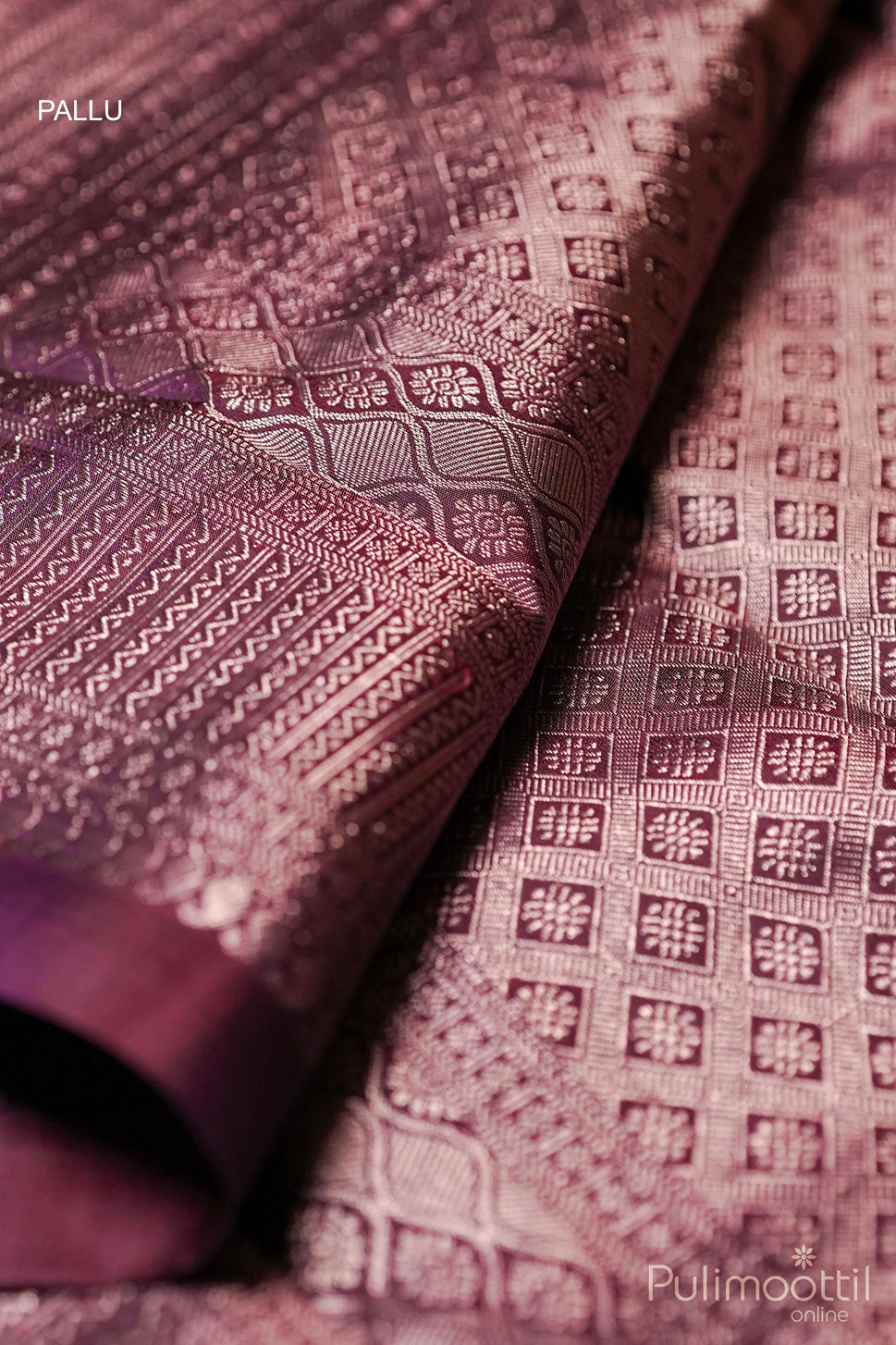 Close-up of purple Kanchipuram silk saree pallu with intricate golden zari patterns, highlighting traditional craftsmanship and luxurious texture.