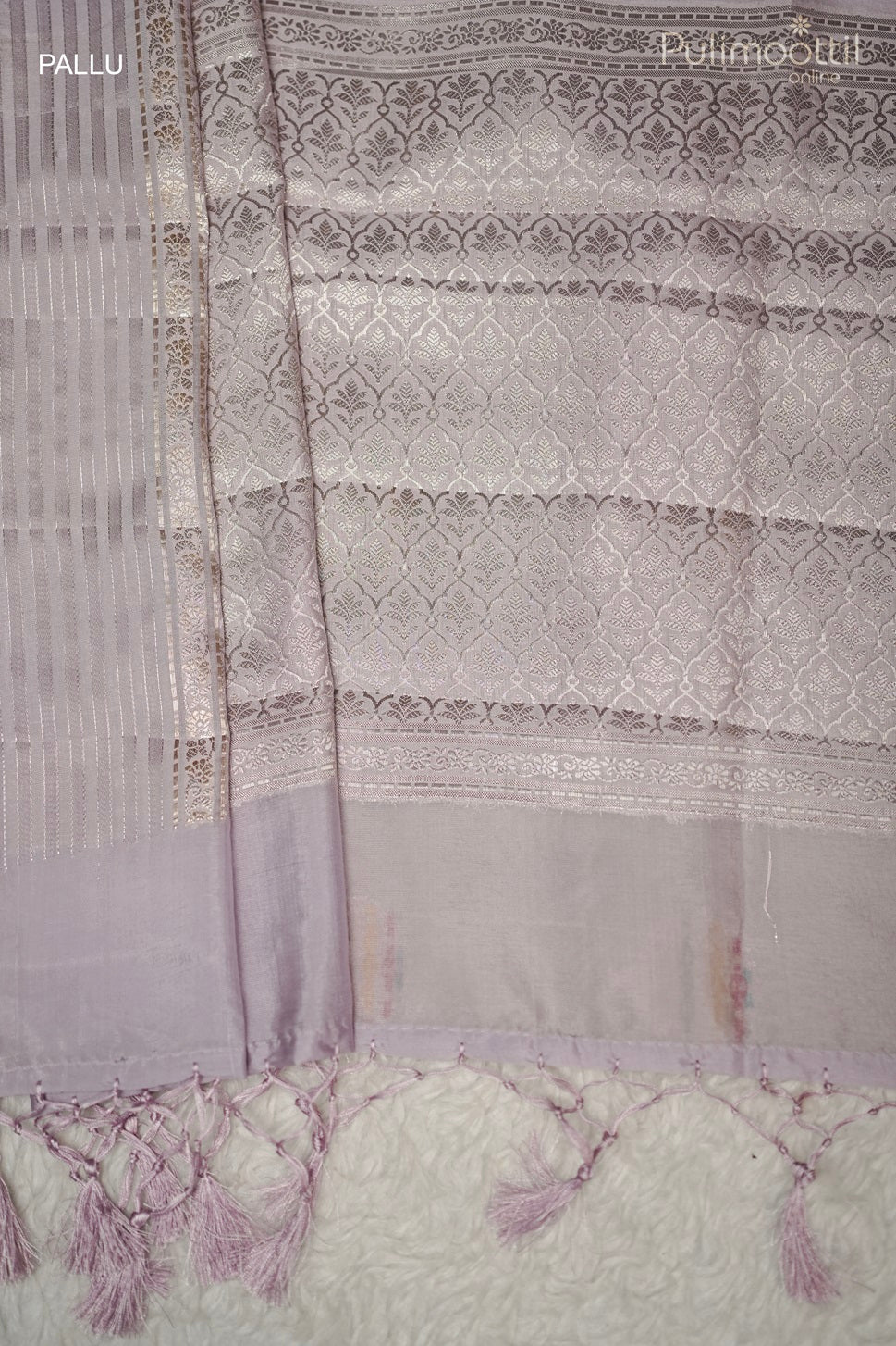 Contrast multithread designer pallu with tassels on an ivory Banarasi silk saree, ideal for bridal saree or elegant party wear occasions.