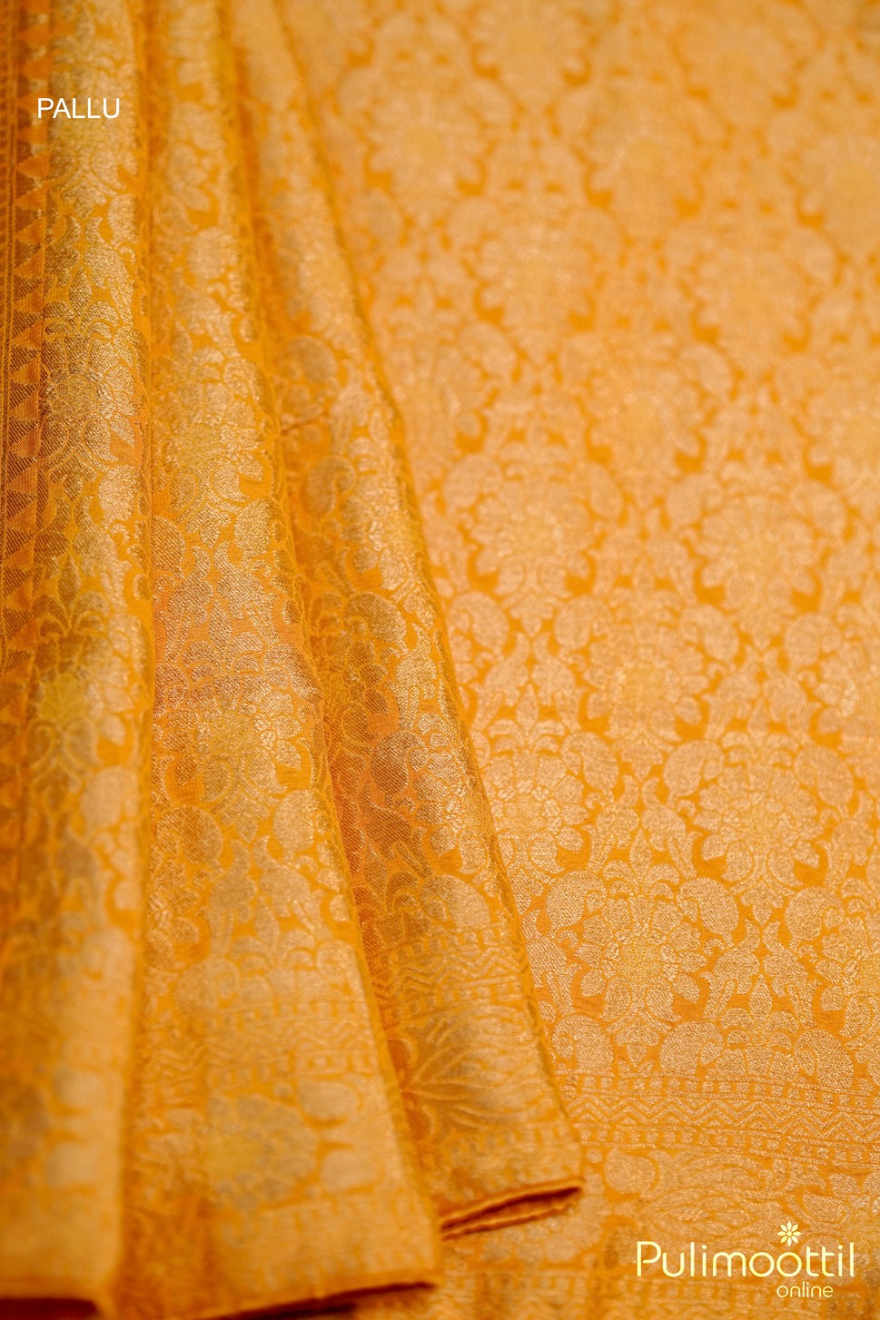 Designer pallu of mustard yellow Banarasi saree with rich golden woven motifs.