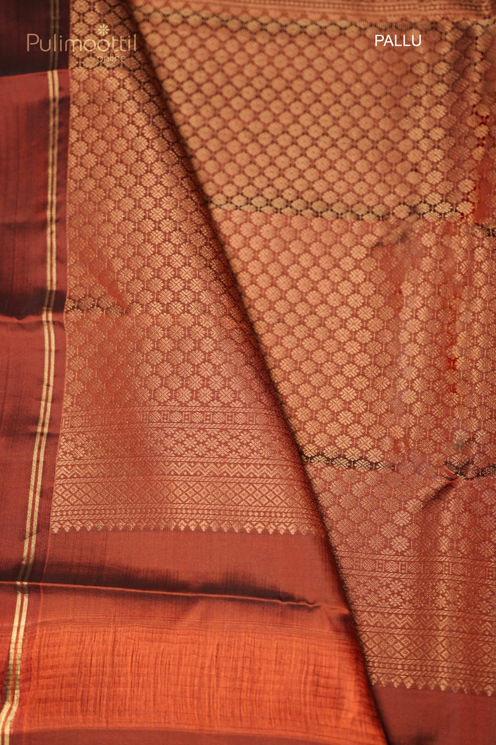 Close-up of floral buttas design on the rust-colored pallu of the saree with intricate golden zari work.