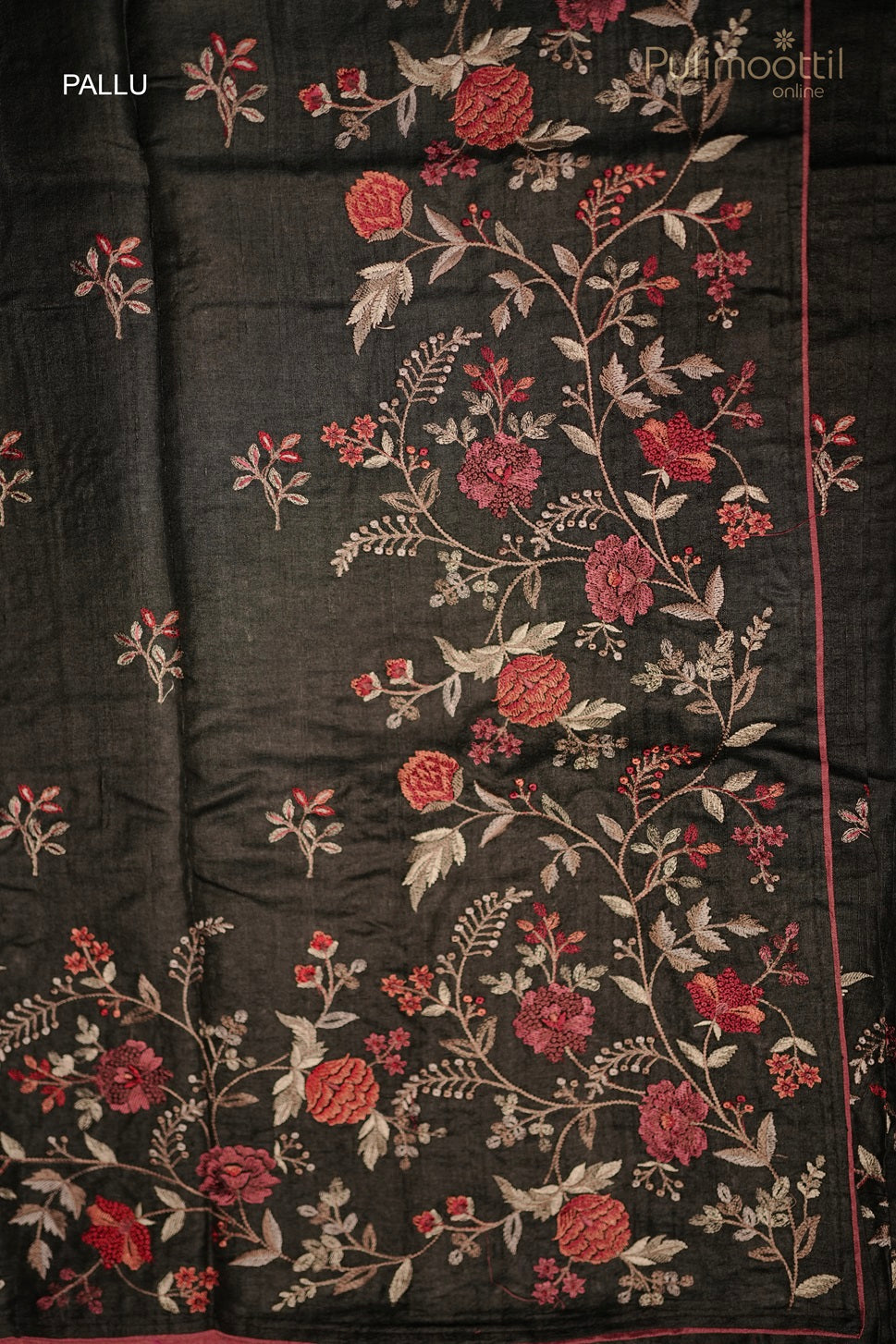 Black saree pallu with intricate red and white floral embroidery, featuring a contrasting pink piping along the edges.