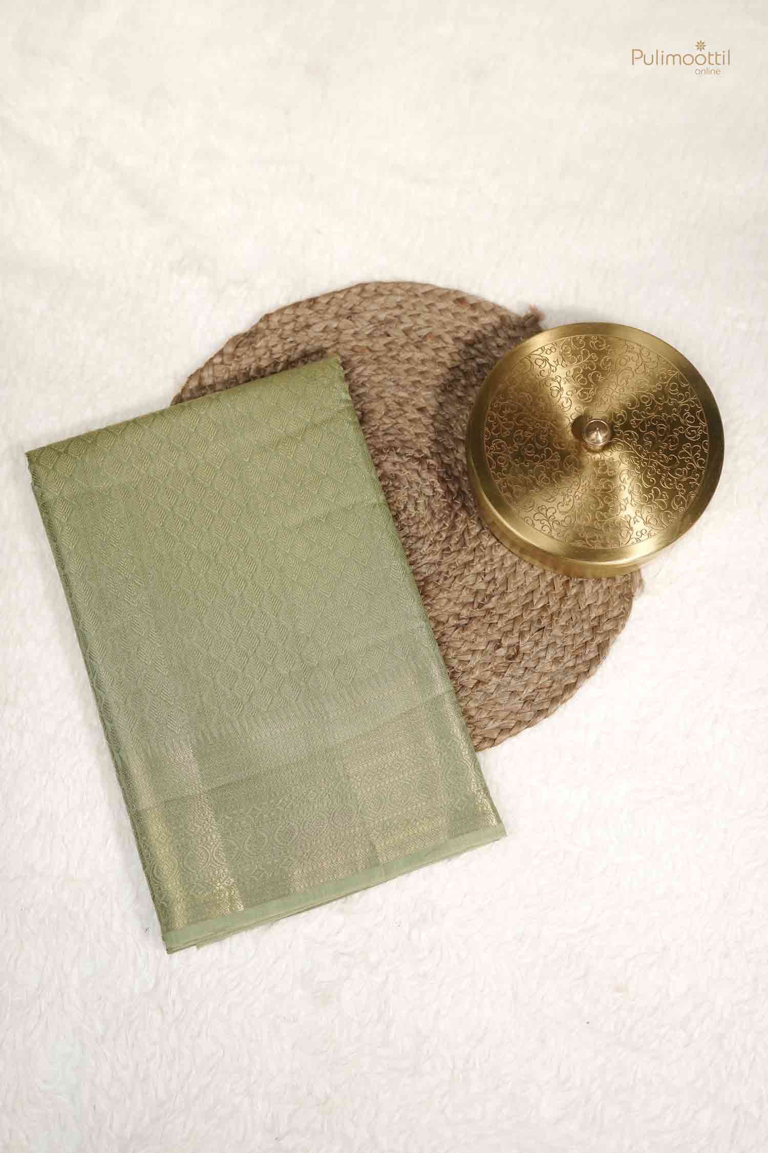 Overhead view of the Pistachio Green Soft Silk Saree folded flat, showing the subtle sheen of the fabric and woven body design.