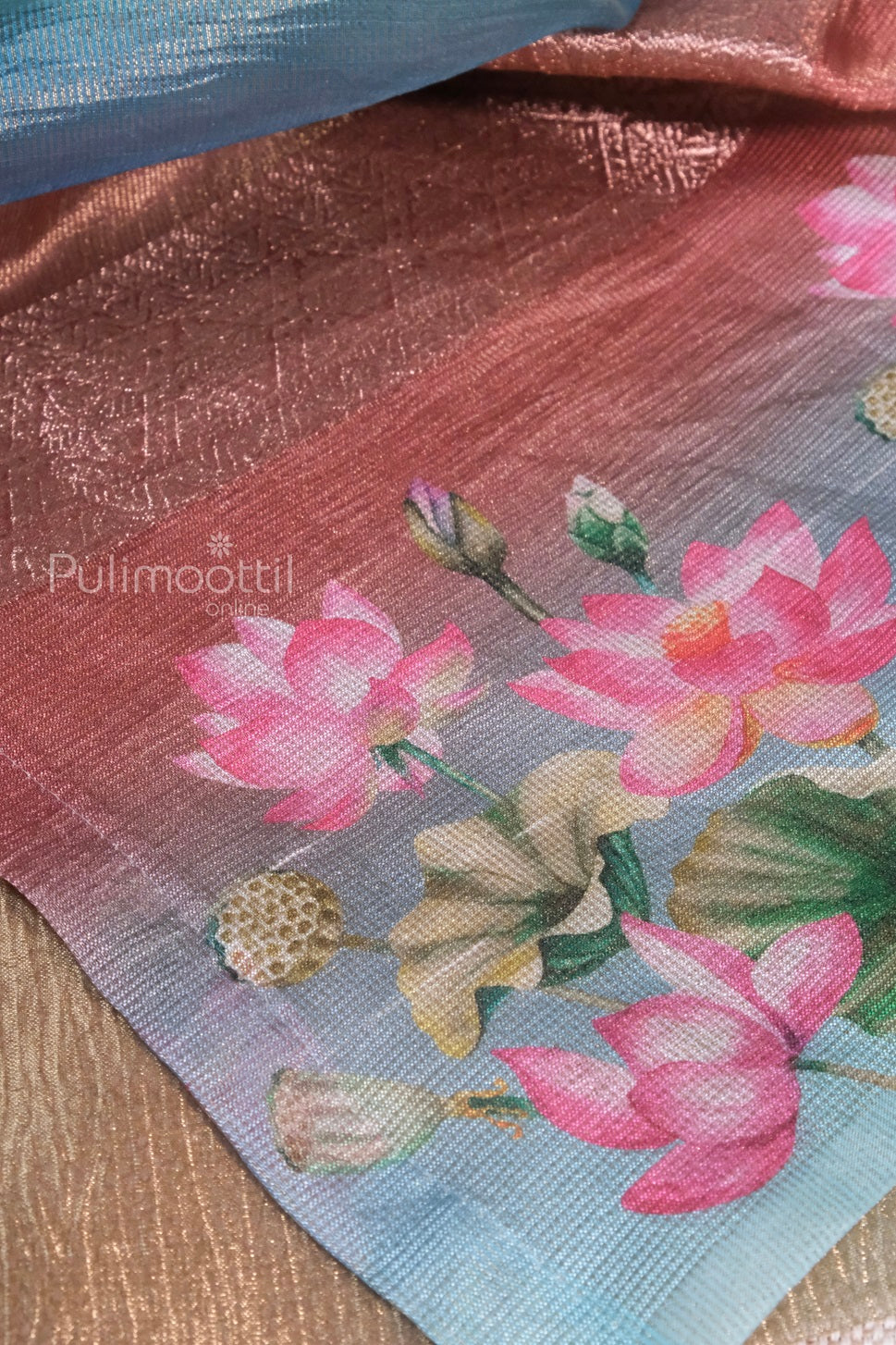 Folded rainbow-colored crushed organza tissue saree showing shimmer texture and multi-toned sheen.