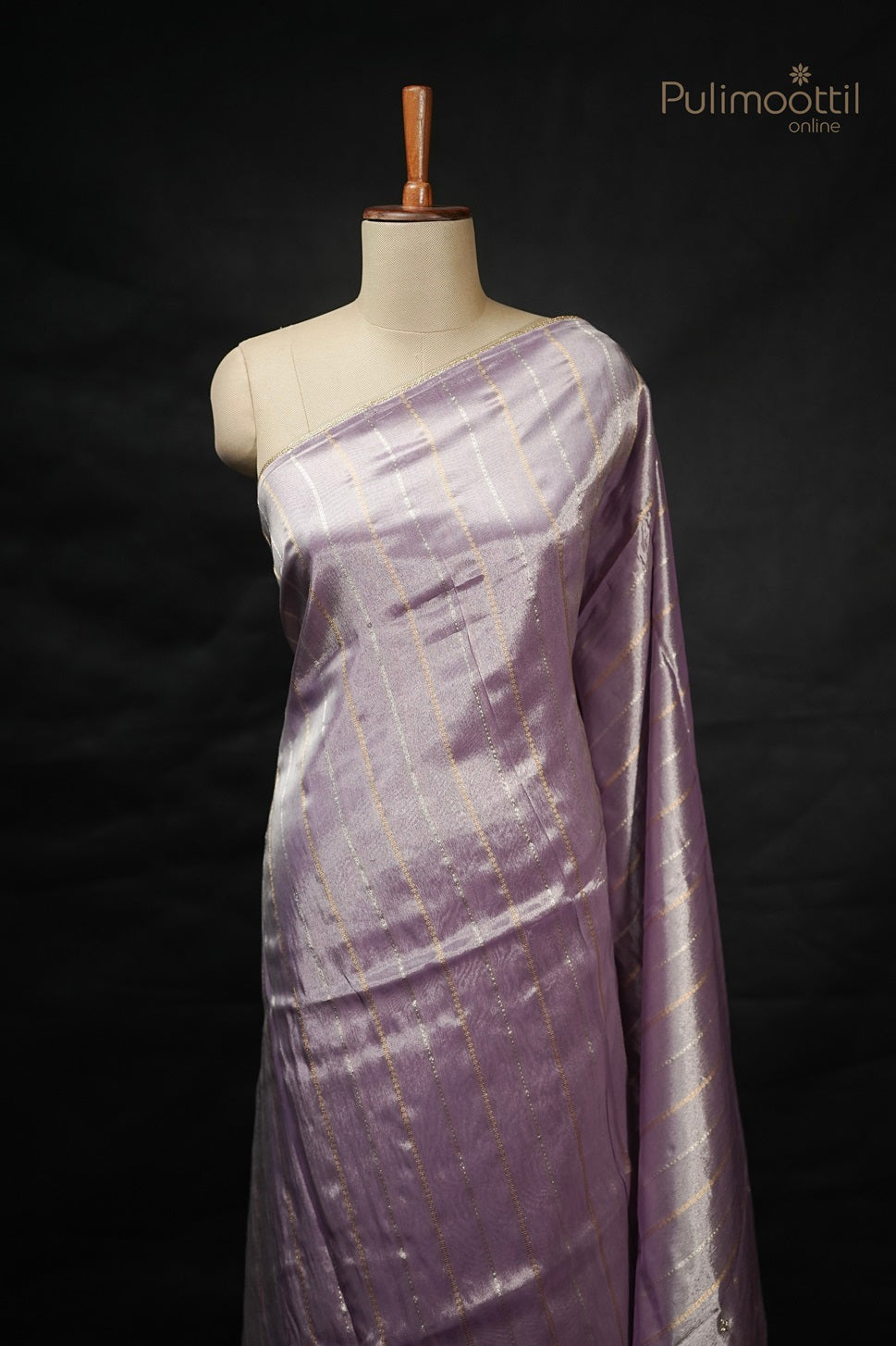 Lavender organza saree with golden and silver stripes draped on mannequin