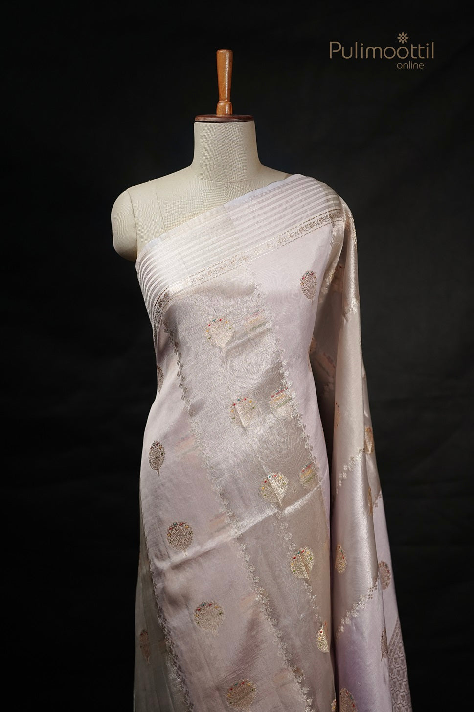 Ivory Banarasi silk saree featuring golden and multithread diagonal designs with a contrasting red border, perfect as a wedding saree or party wear from Pulimoottil Silks.