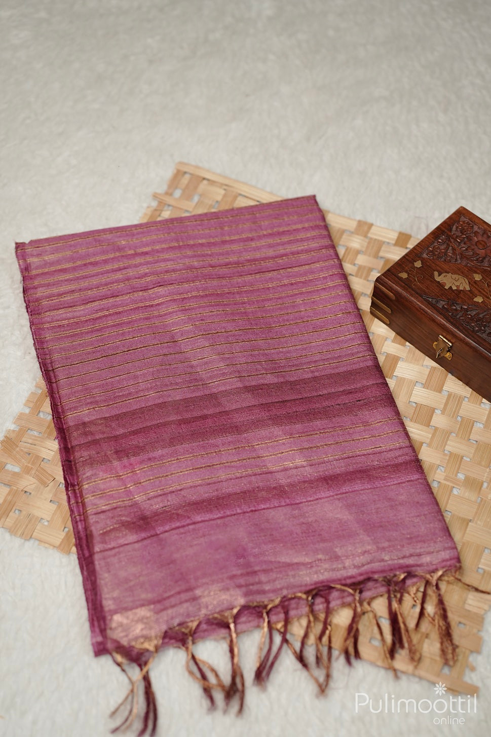 Purple scarf with fringes on a textured surface