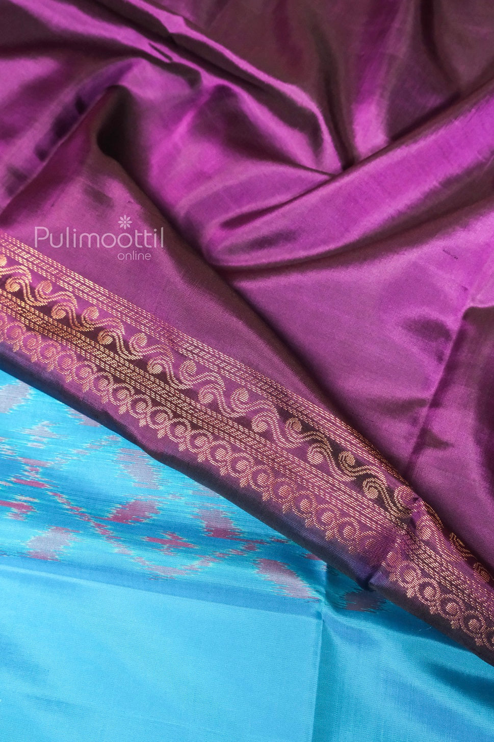 Aqua blue pure soft silk saree with purple Ikat print and contrasting rich purple pallu featuring golden zari woven border.