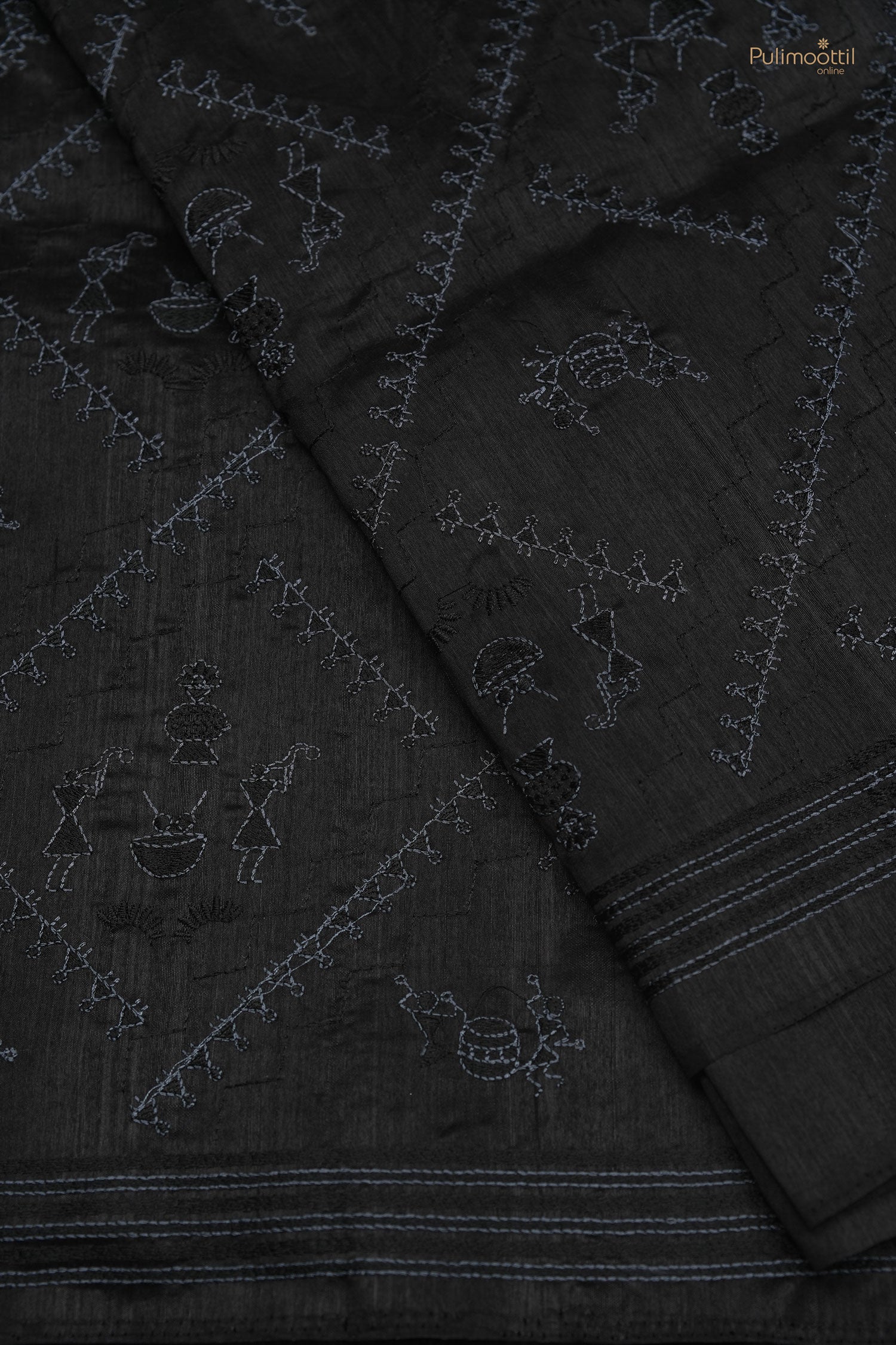 Black Semi Tussar saree with intricate tribal embroidery and woven stripe border