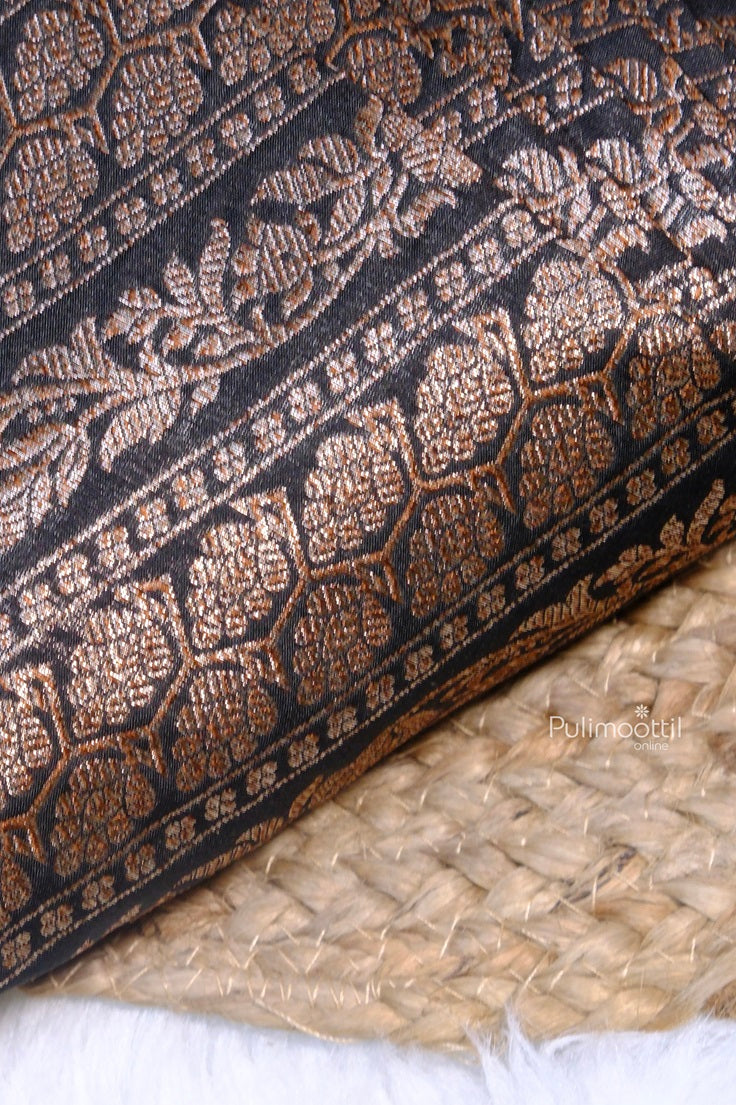 Close-up of the saree's, Folded  highlighting the delicate woven detailing and contrasting textures.
