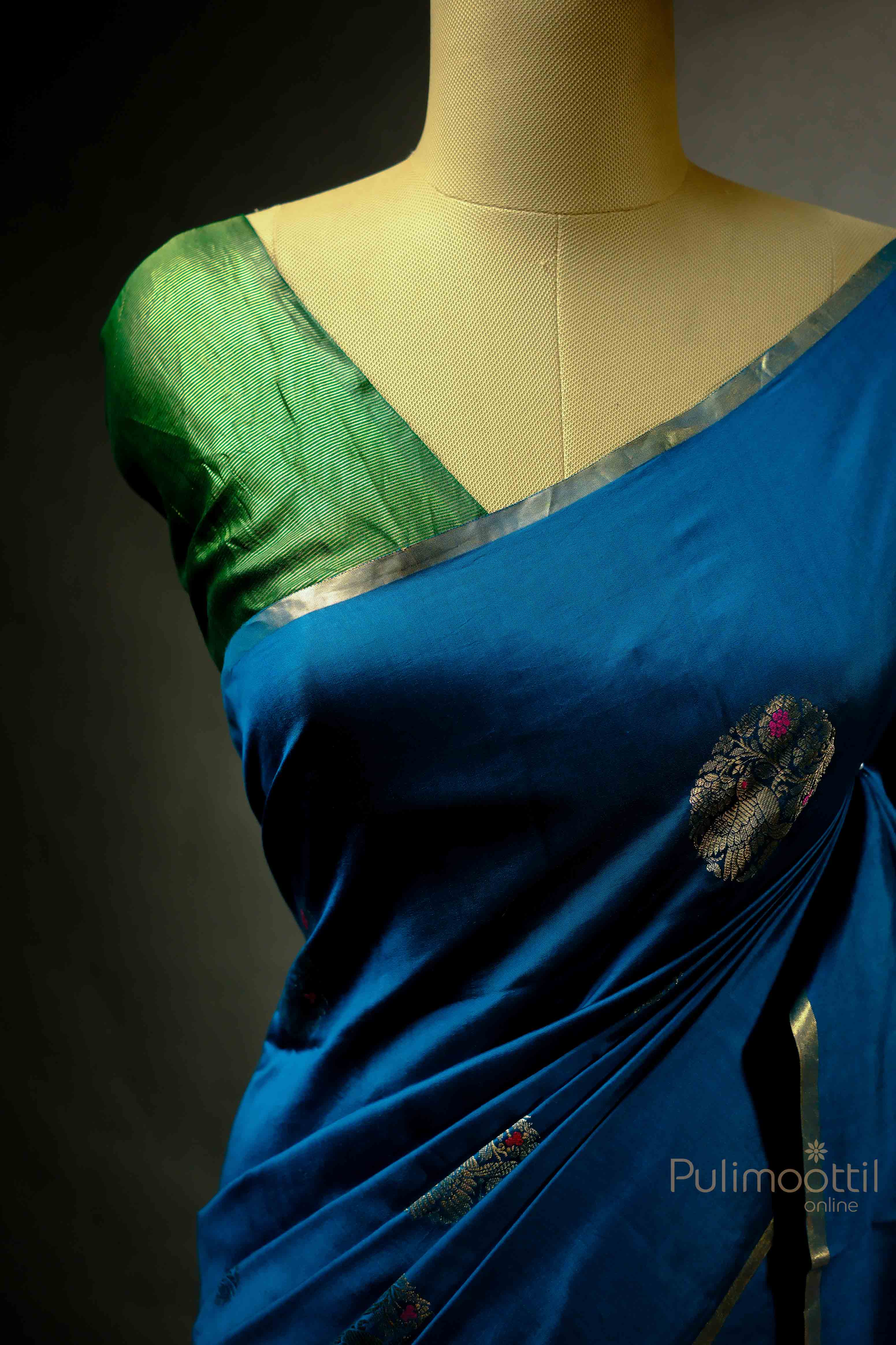 Blue Chiniya Silk Saree with golden motifs, draped from a different angle, highlighting the intricate design.