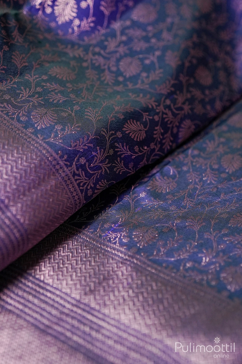 Blue Kanchipuram brocade wedding saree with rose gold zari floral weaving and designer border close-up