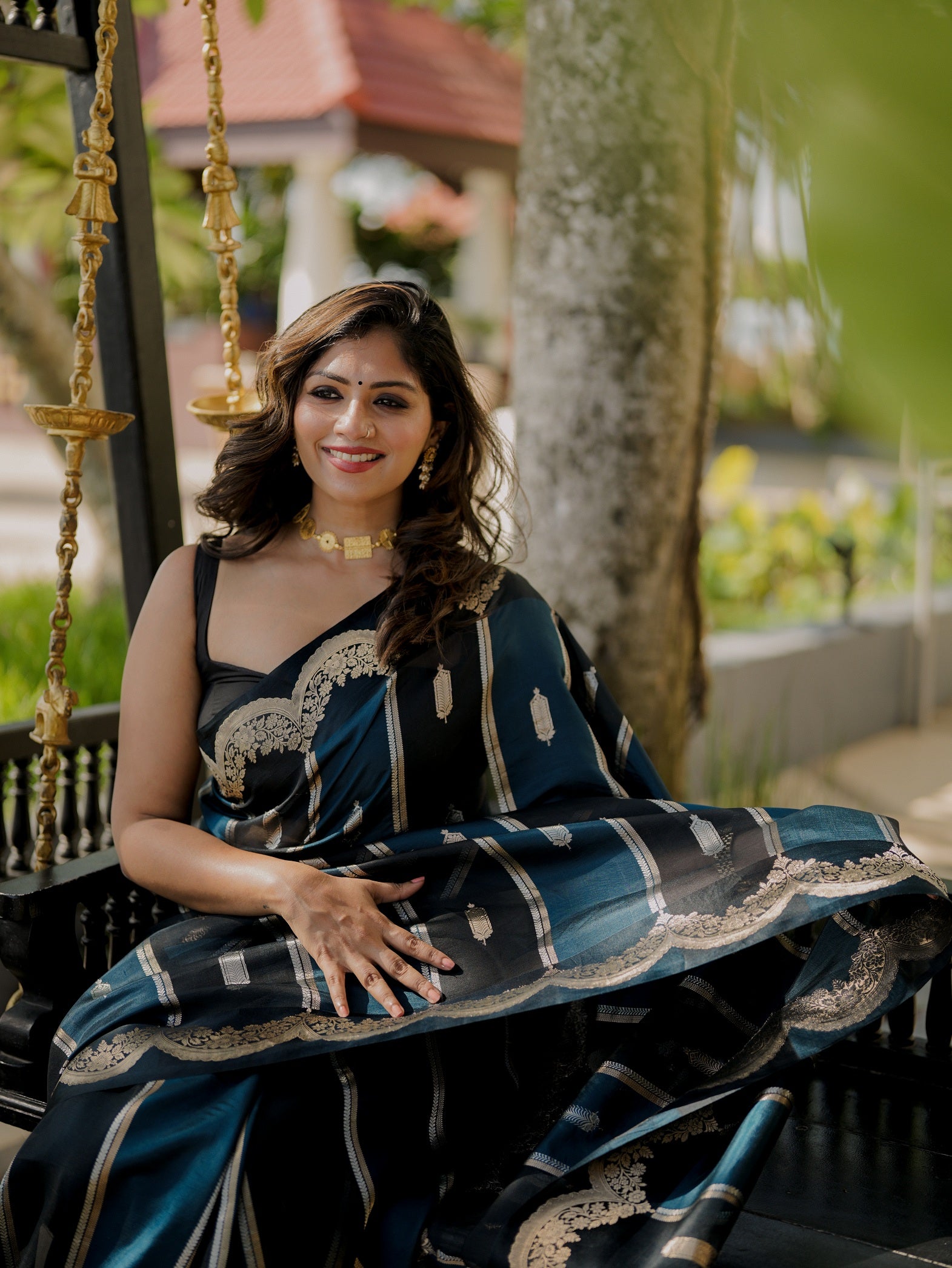 Close-up of the Pure Mango Silk Banarasi saree pallu in blue and black with detailed paisley motifs and antique zari work.