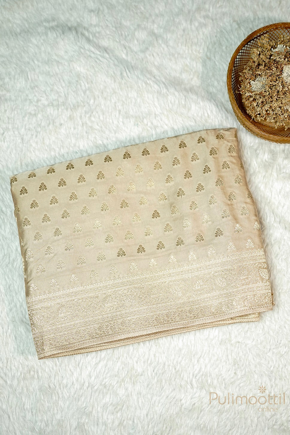 Chikku Colour Uppada Banarasi saree, showcasing light golden zari buttas and Banarasi border, neatly folded.