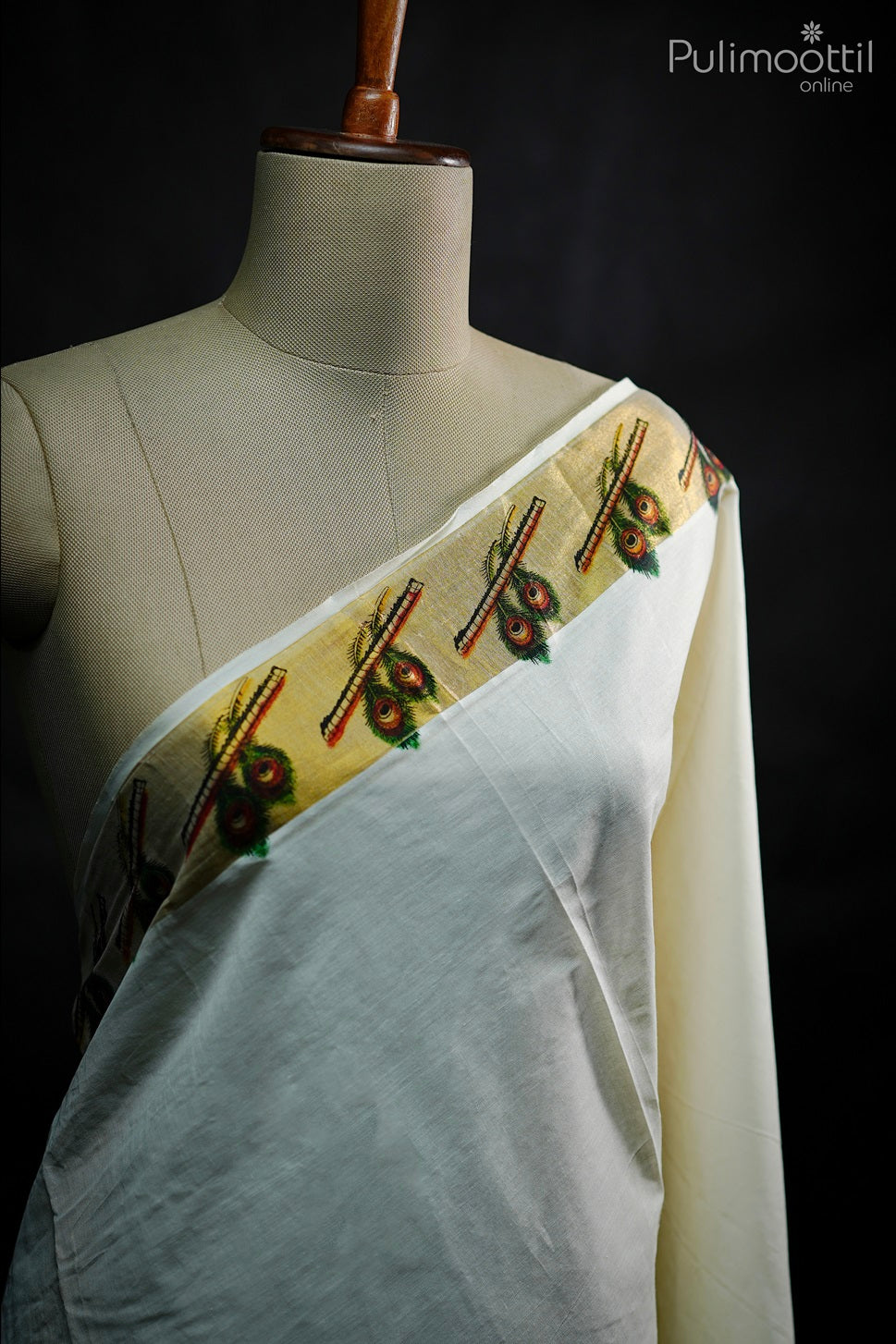 printed floral motifs in red and green on golden-yellow zari border of plain white cotton saree.