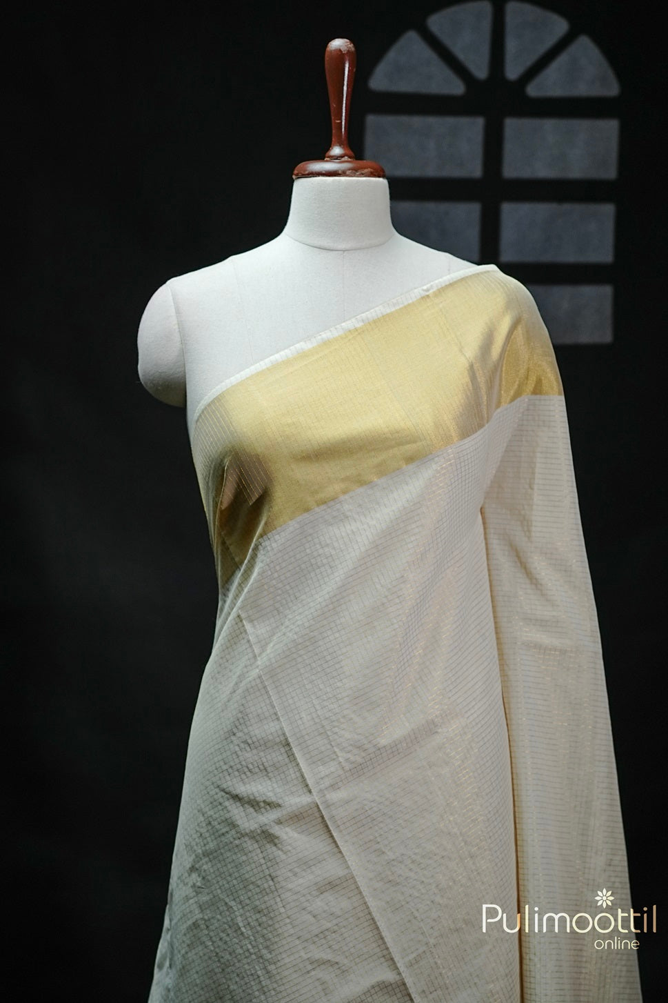 Cream Colour Kerala Traditional Handloom Saree featuring golden zari check design and a delicate tissue border, elegantly draped.