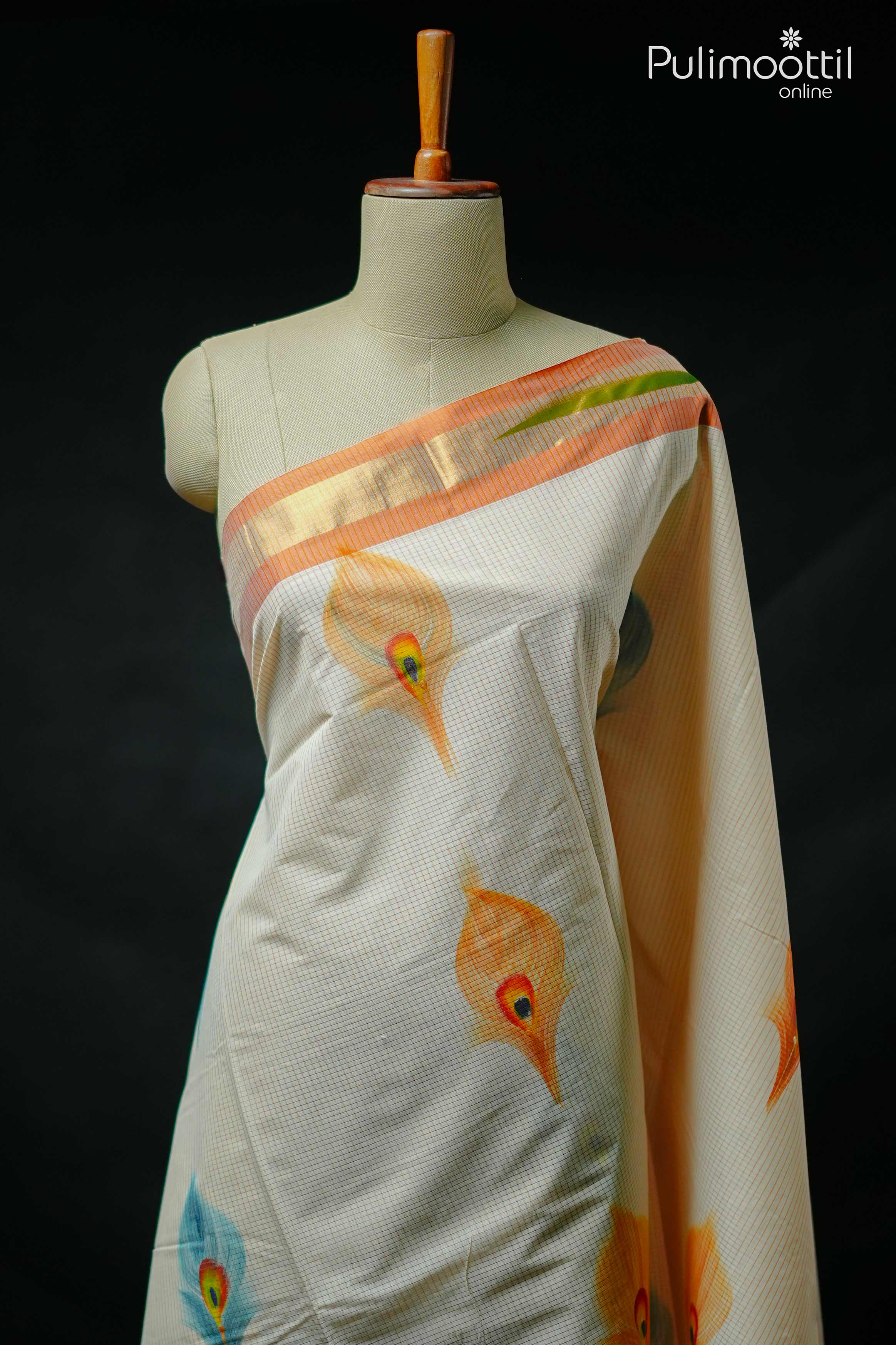 Cream Kerala tissue saree with subtle grid pattern, adorned with multicolor peacock feather motifs and golden zari border, displayed on mannequin.