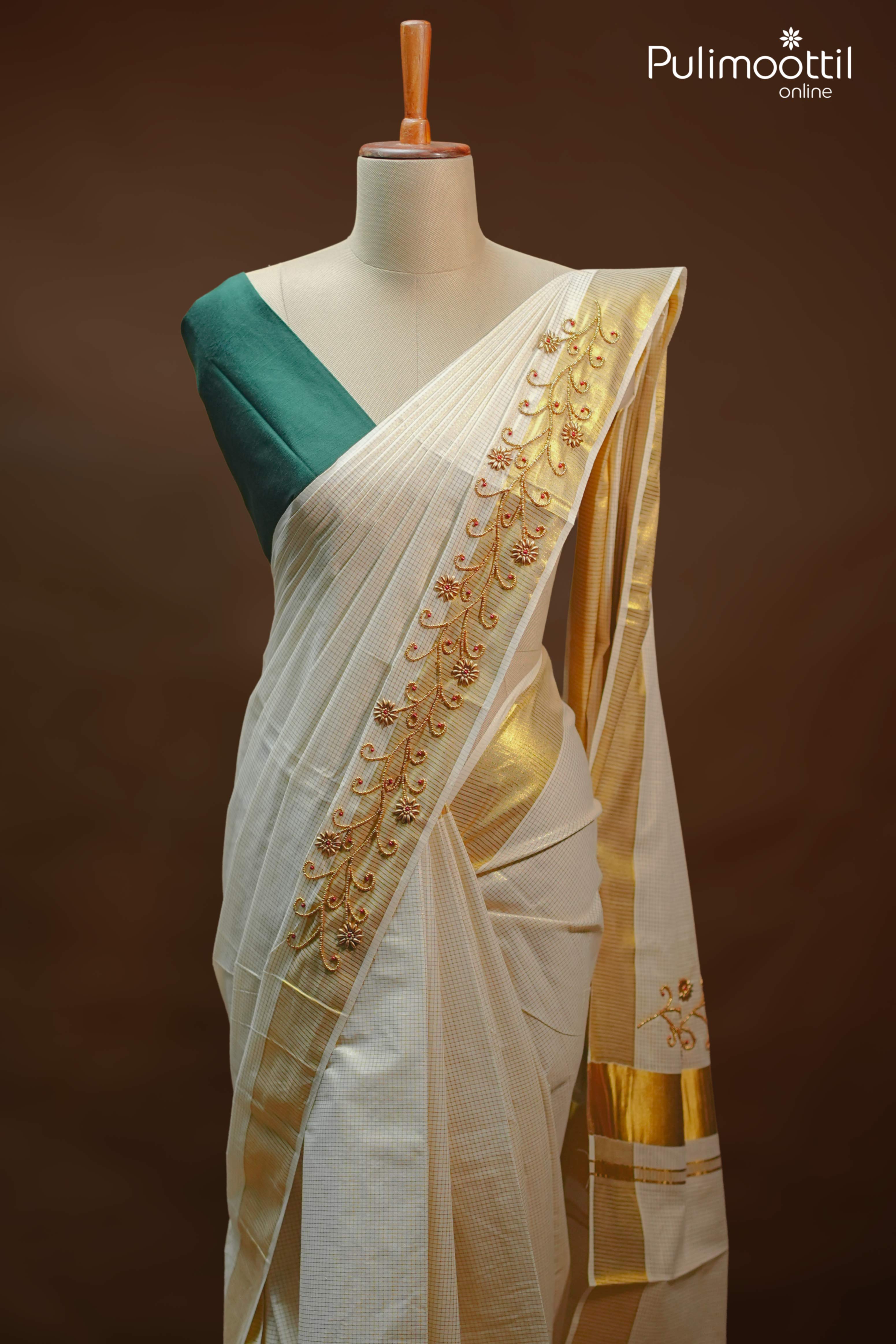 Cream colour traditional Kerala set saree with golden zari check pattern and bead work on pallu, paired with tissue border and green blouse
