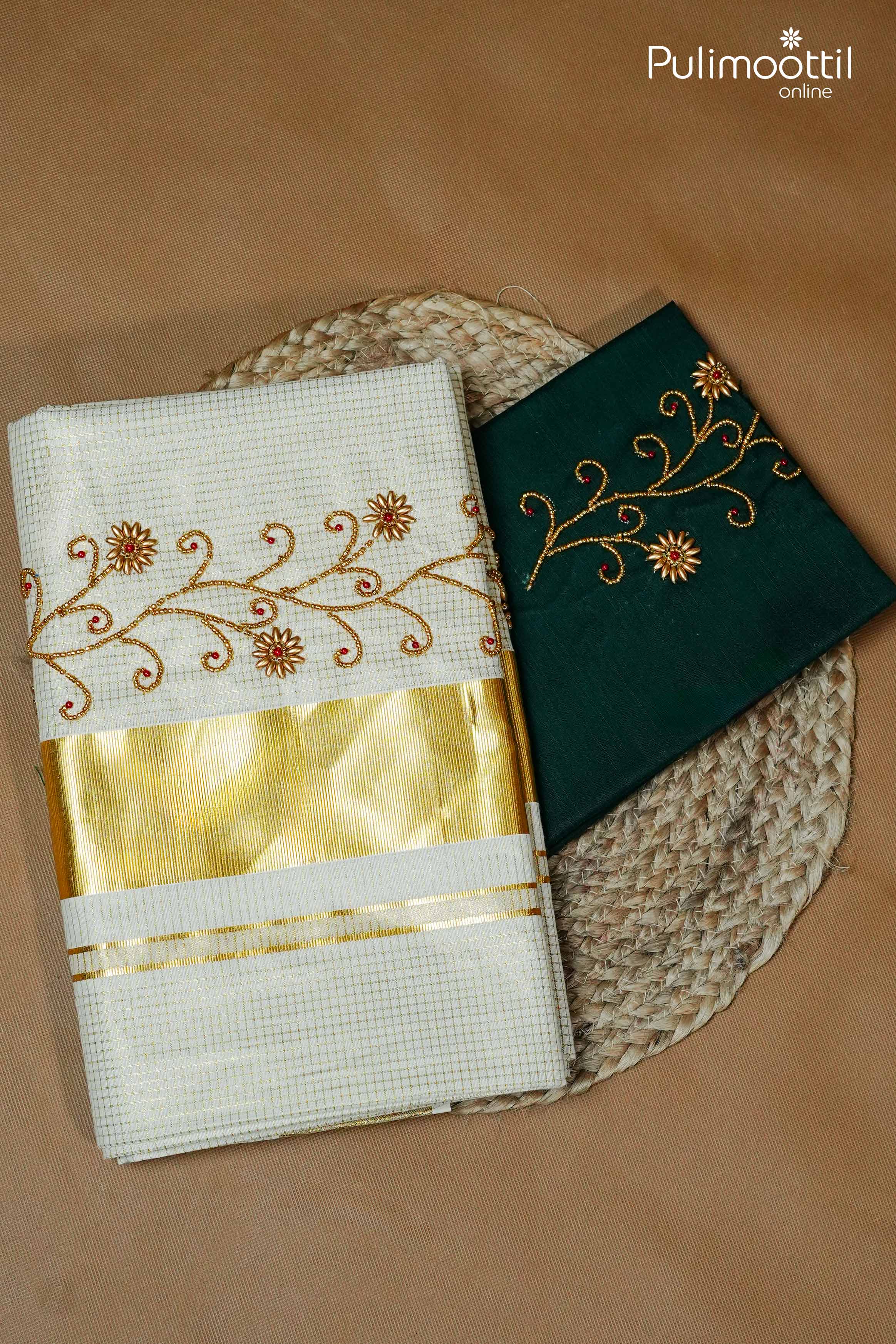 Folded cream Kerala set saree with golden zari border and bead floral embroidery, paired with matching green blouse piece with golden embroidery