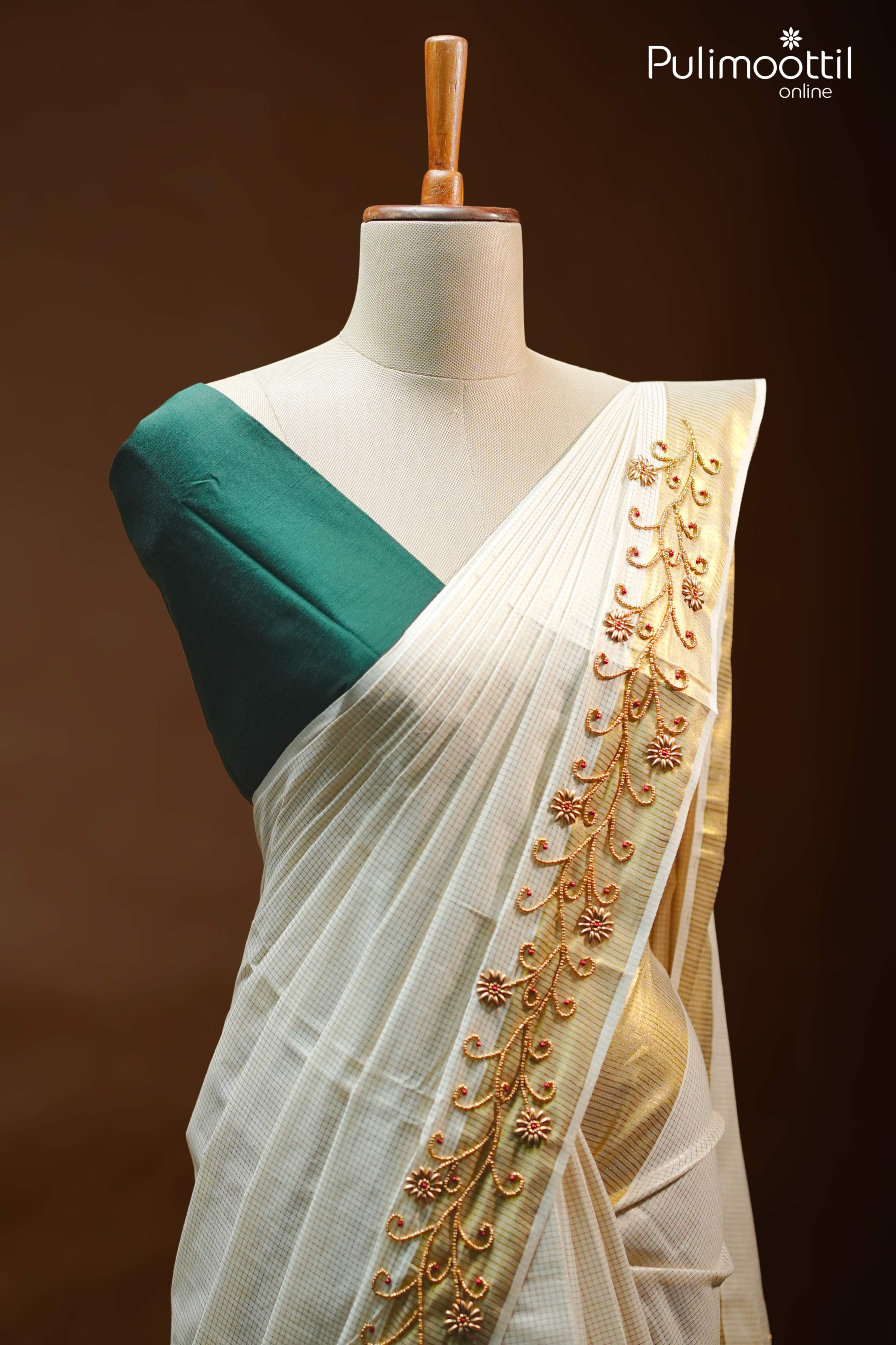 Cream Kerala set saree with golden zari check and bead floral embroidery on tissue border, draped on mannequin with green blouse