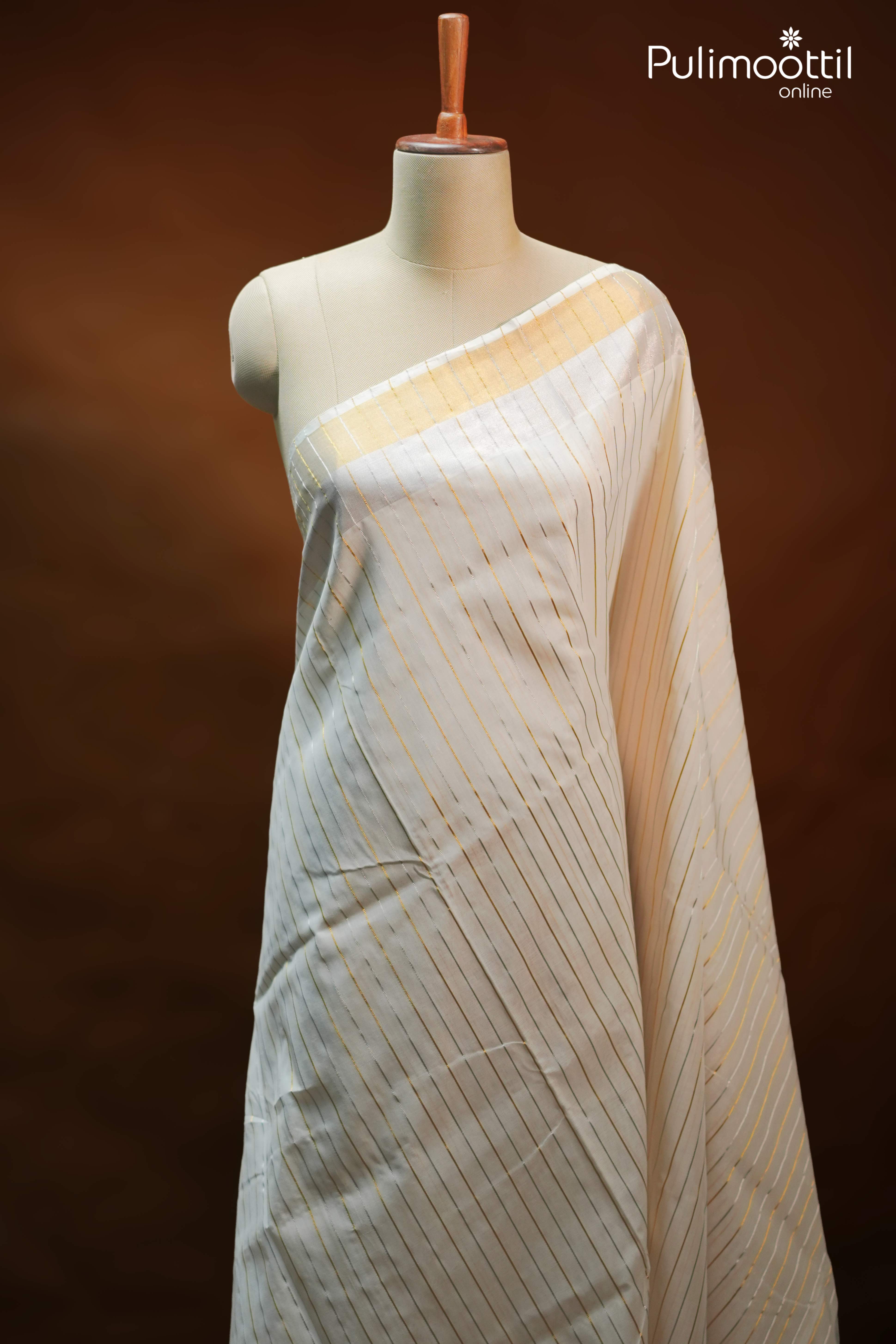 Cream Kerala set saree with mixed golden and silver zari stripes, draped on mannequin, featuring matching pallu and blouse