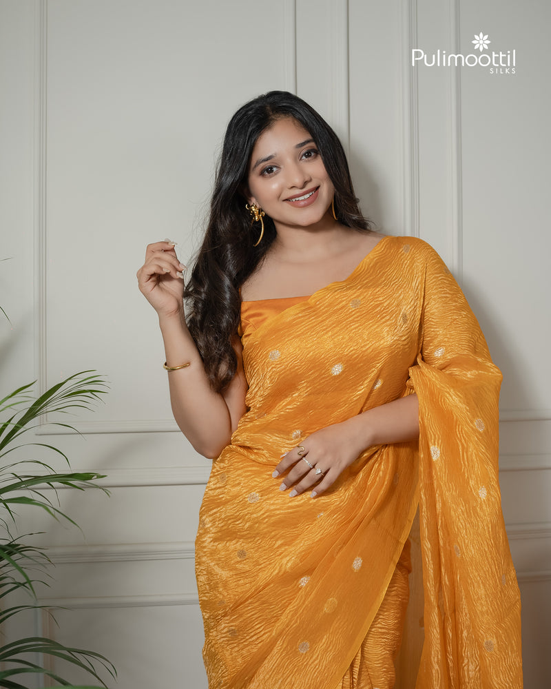 Yellow color crushed Organza saree.