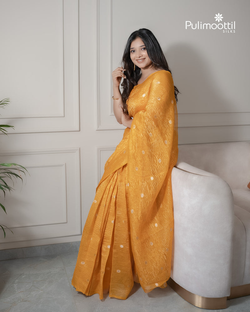Yellow color crushed Organza saree.
