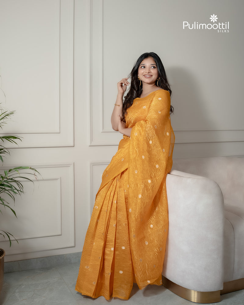 Yellow color crushed Organza saree.