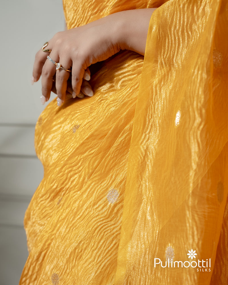 Yellow color crushed Organza saree.