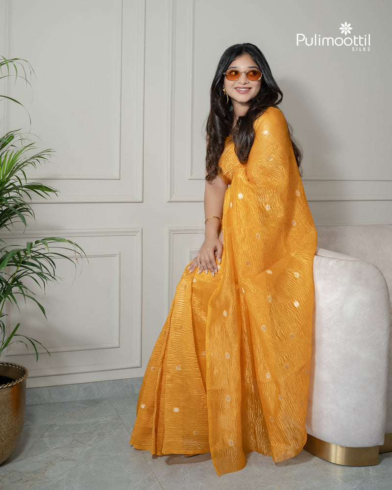 Yellow color crushed Organza saree.