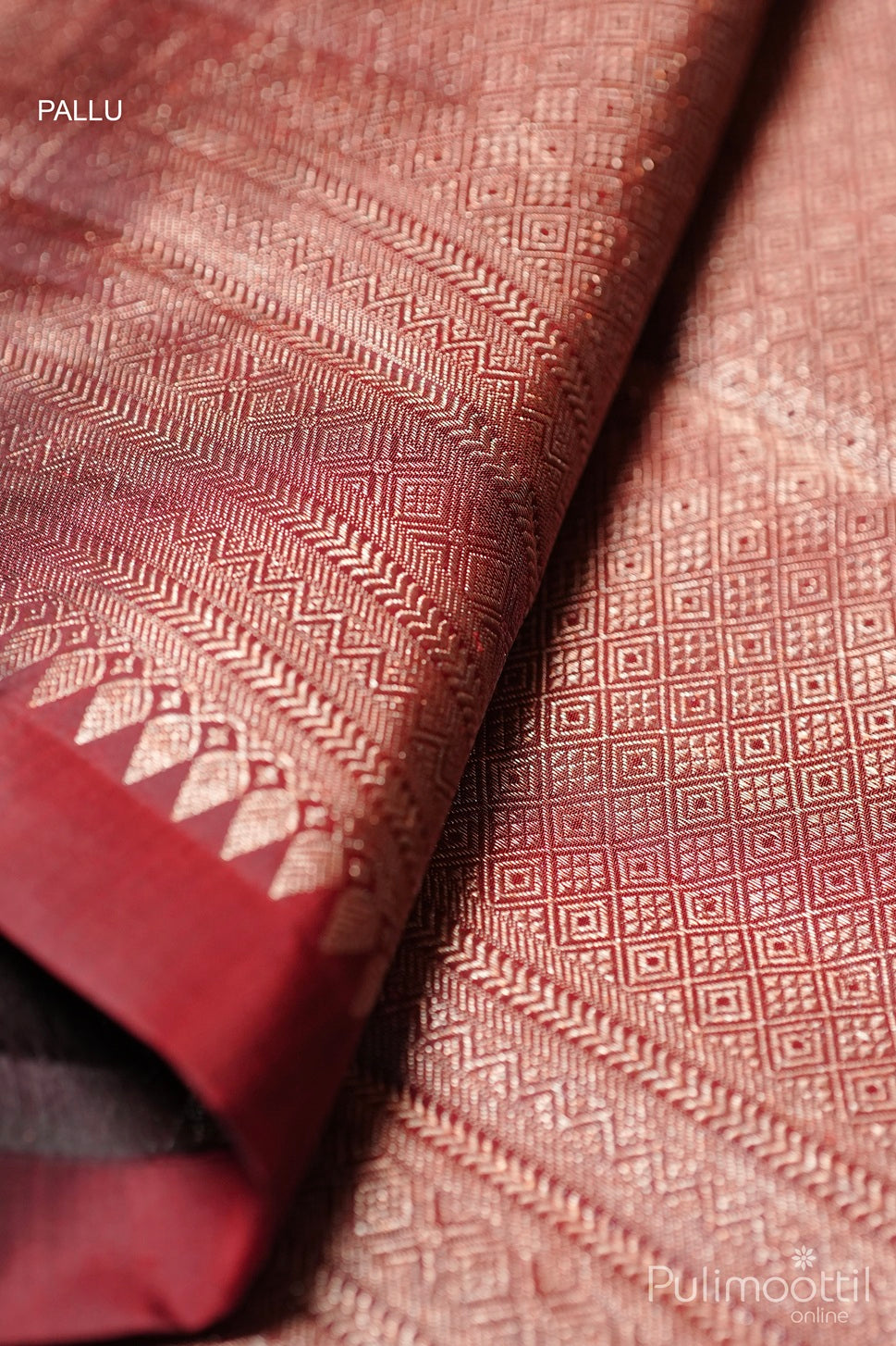 Dark maroon Kanchipuram brocade wedding saree pallu with antique zari geometric and striped weaving pattern close-up
