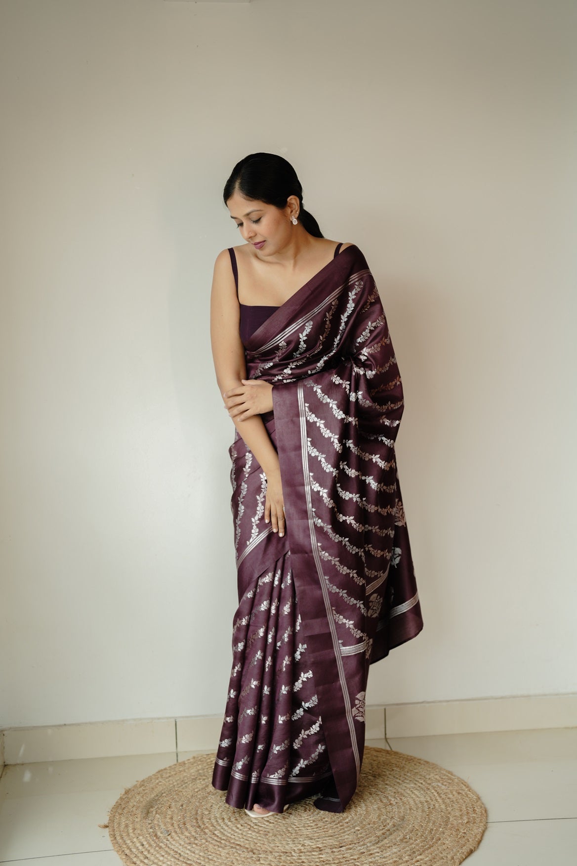 Full view of deep coffee mango silk saree with intricate silver and golden zari floral motifs and elegant plain border.