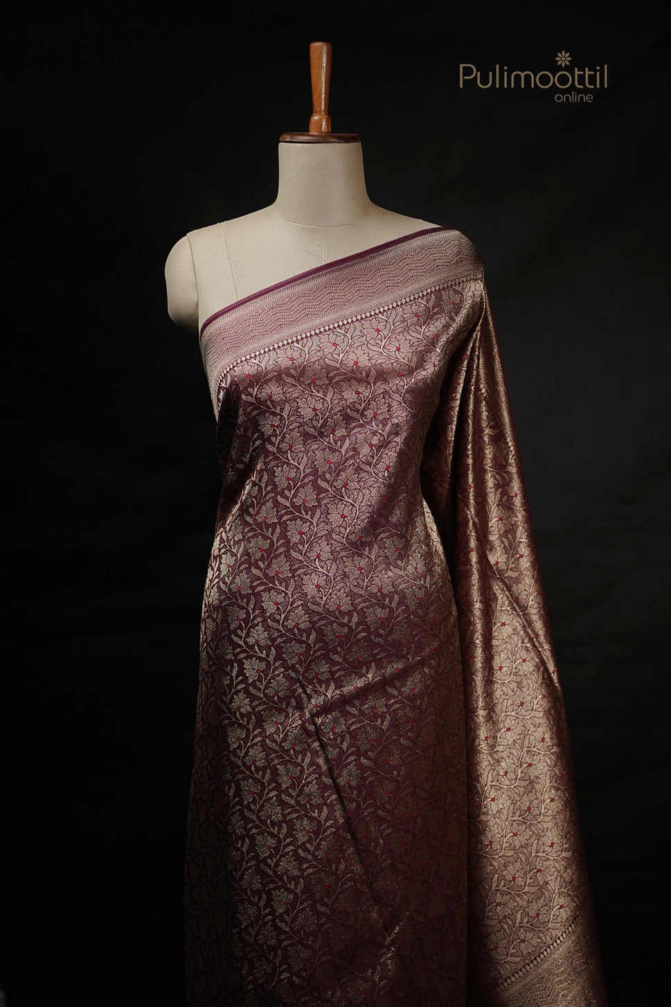 Mannequin draped in a Maroon-Gold Dual-Tone Silk Saree with all-over gold floral zari motifs and a heavy woven border.