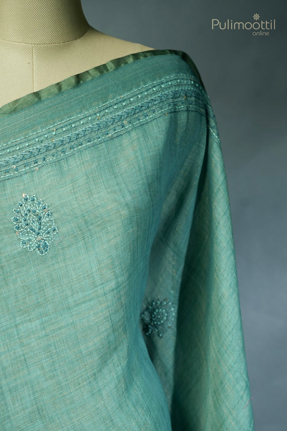 Light teal green-colored hand-embroidered semi linen saree