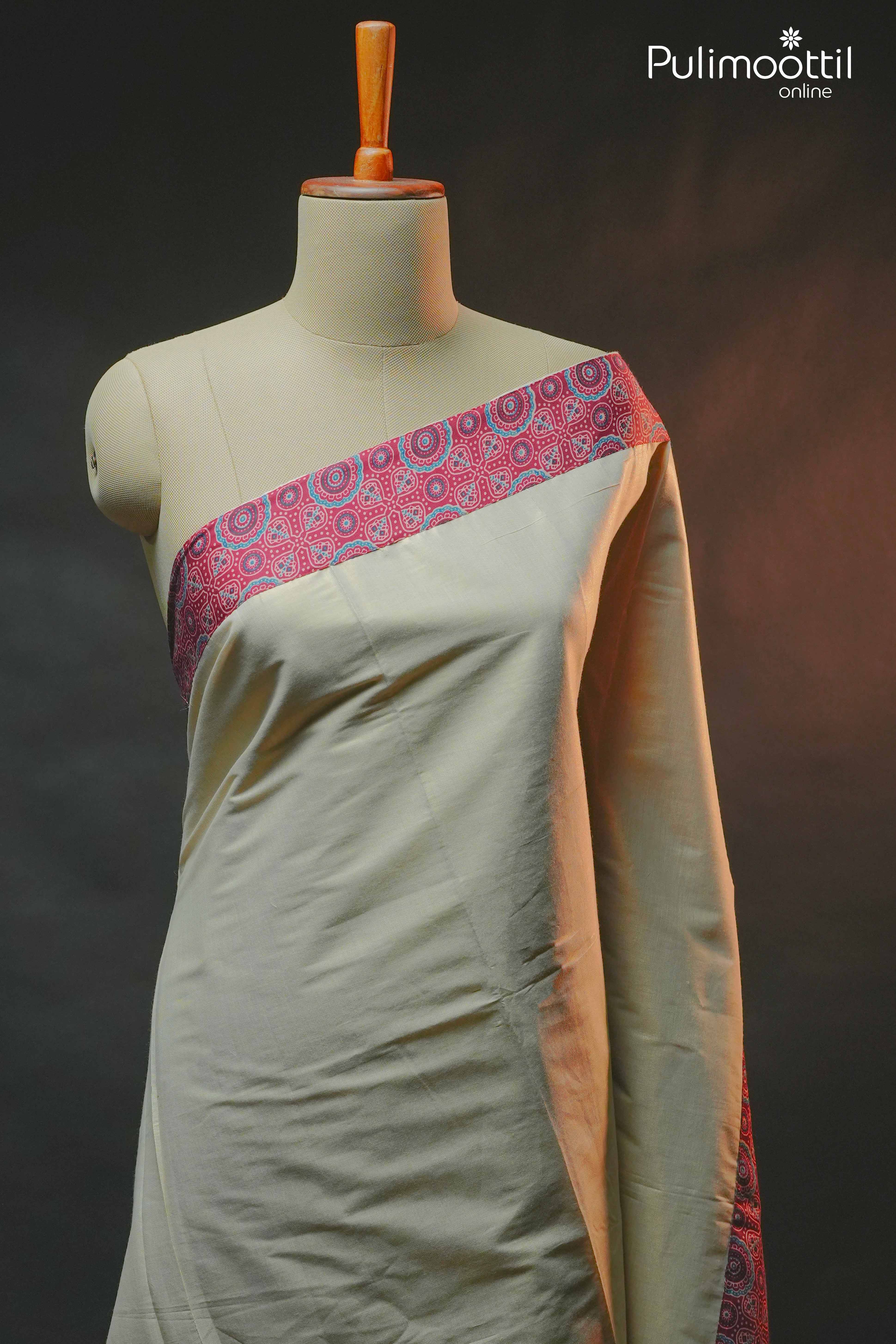 Golden tissue saree with plain body and contrast maroon Ajrakh printed border, draped on mannequin.