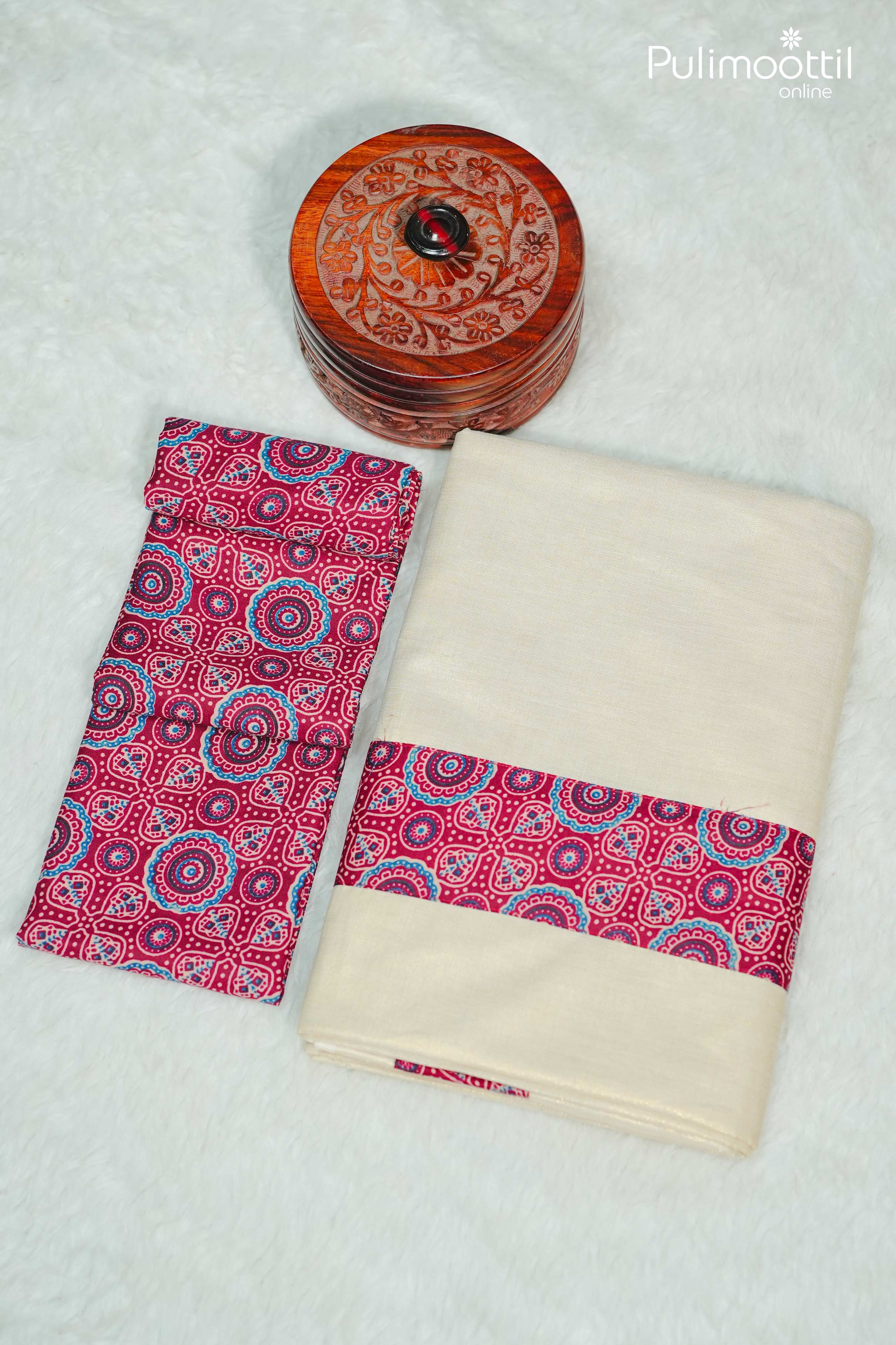 Close-up of maroon Ajrakh printed blouse fabric with intricate circular motifs in blue and beige.