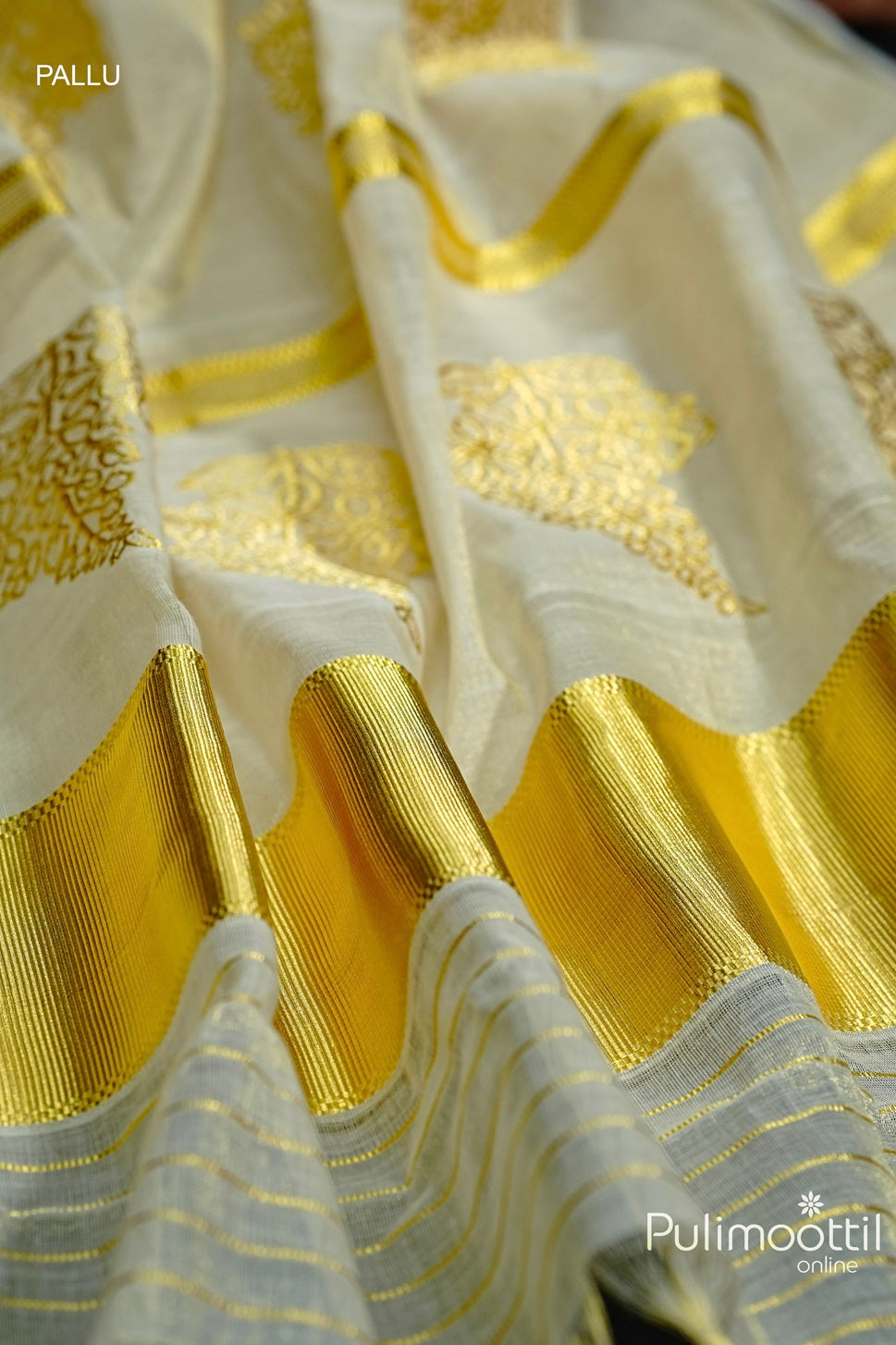 Golden Tissue Kerala Traditional Handloom Set Saree with golden zari floral buttas and a tissue border showcaseing the pallu portion of the saree

